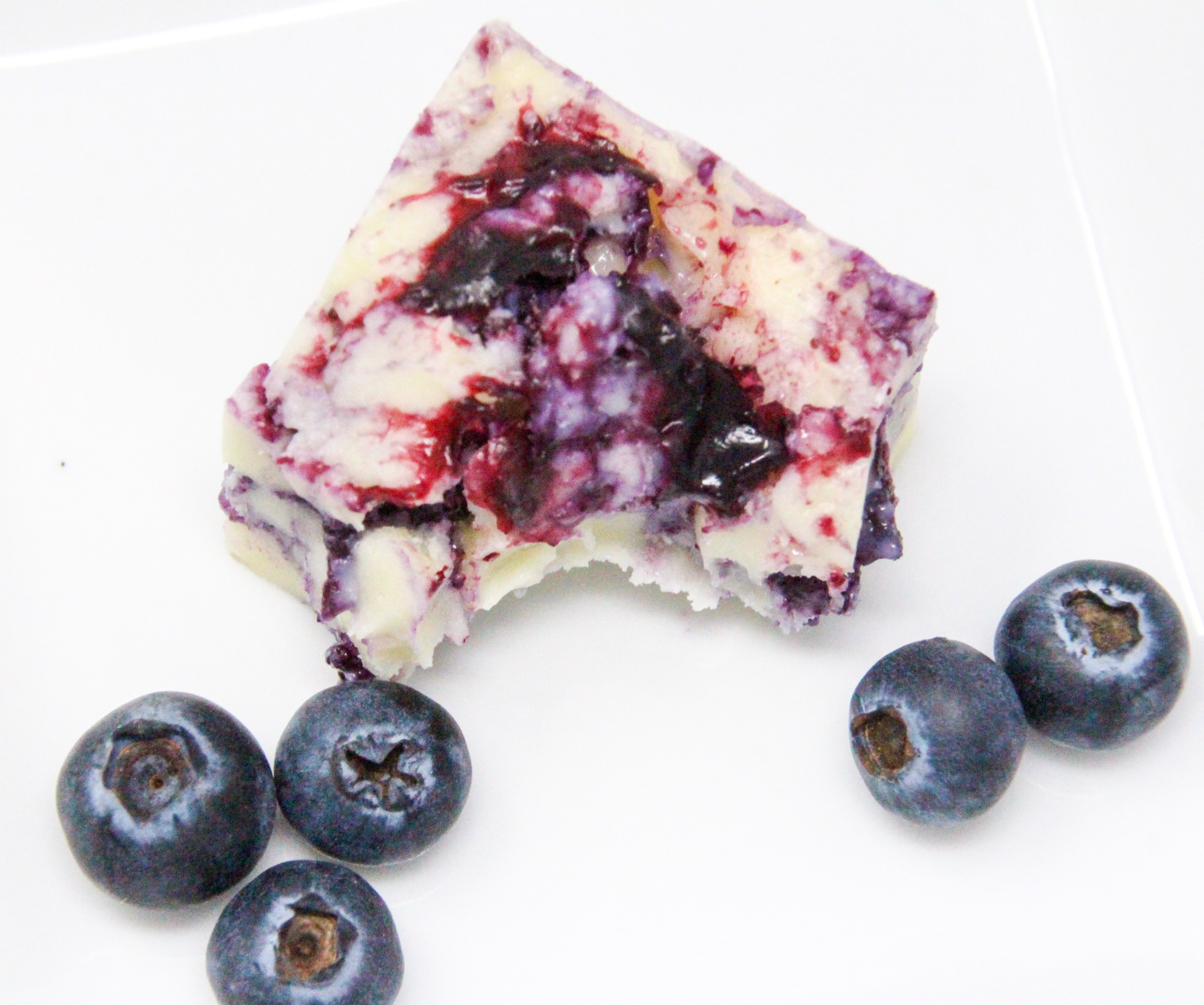 White chocolate layered with a fresh blueberry coulis combines two delectable tastes into one delicious Blueberry-and-Cream Fudge candy. Recipe shared with permission granted by Amanda Flowers, author of BLUEBERRY BLUNDER.