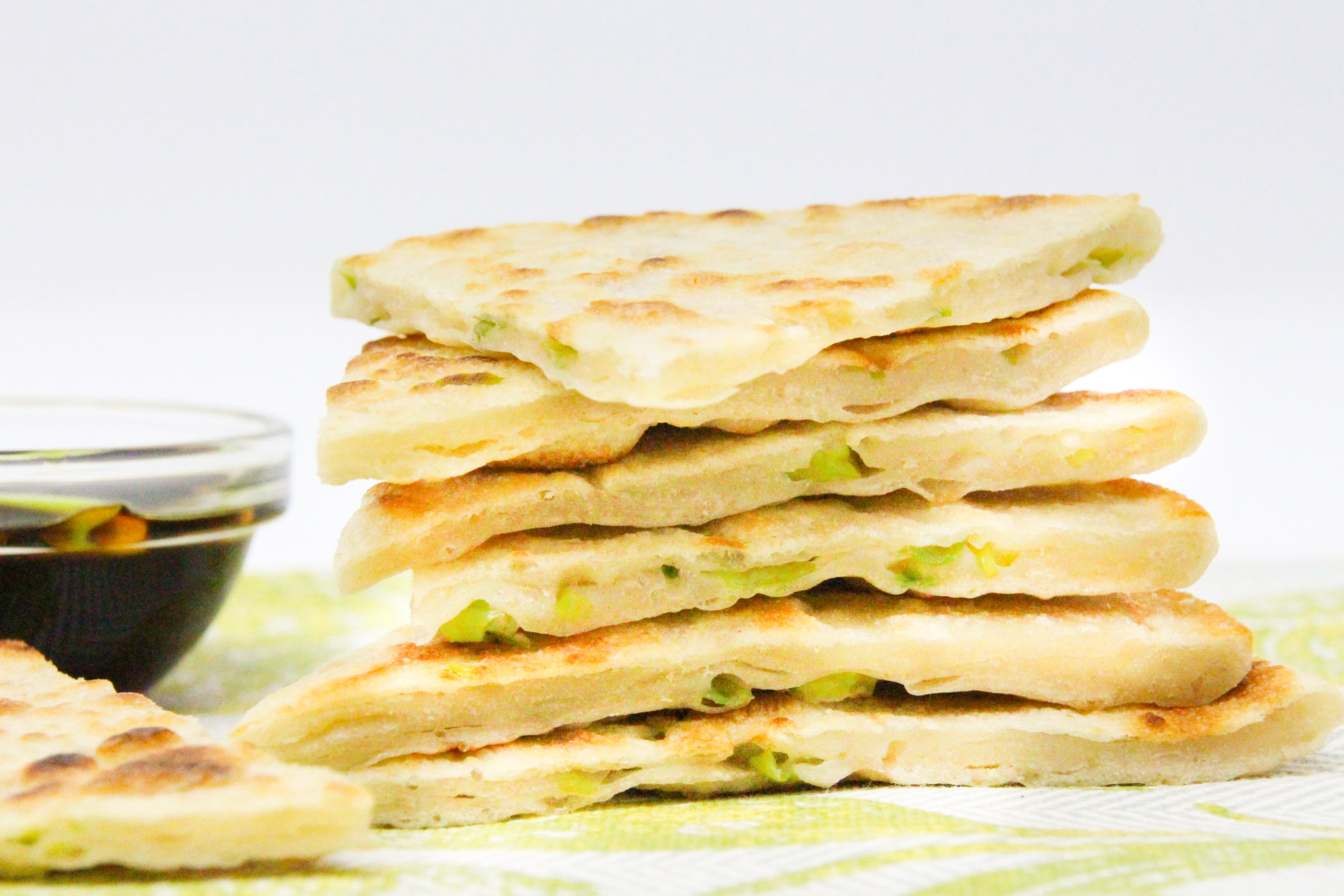 A few super simple ingredients and a hot skillet are all that's necessary to whip up delicious Scallion Pancakes. Recipe shared with permission granted by Jennifer J. Chow, author of HOT POT MURDER. 