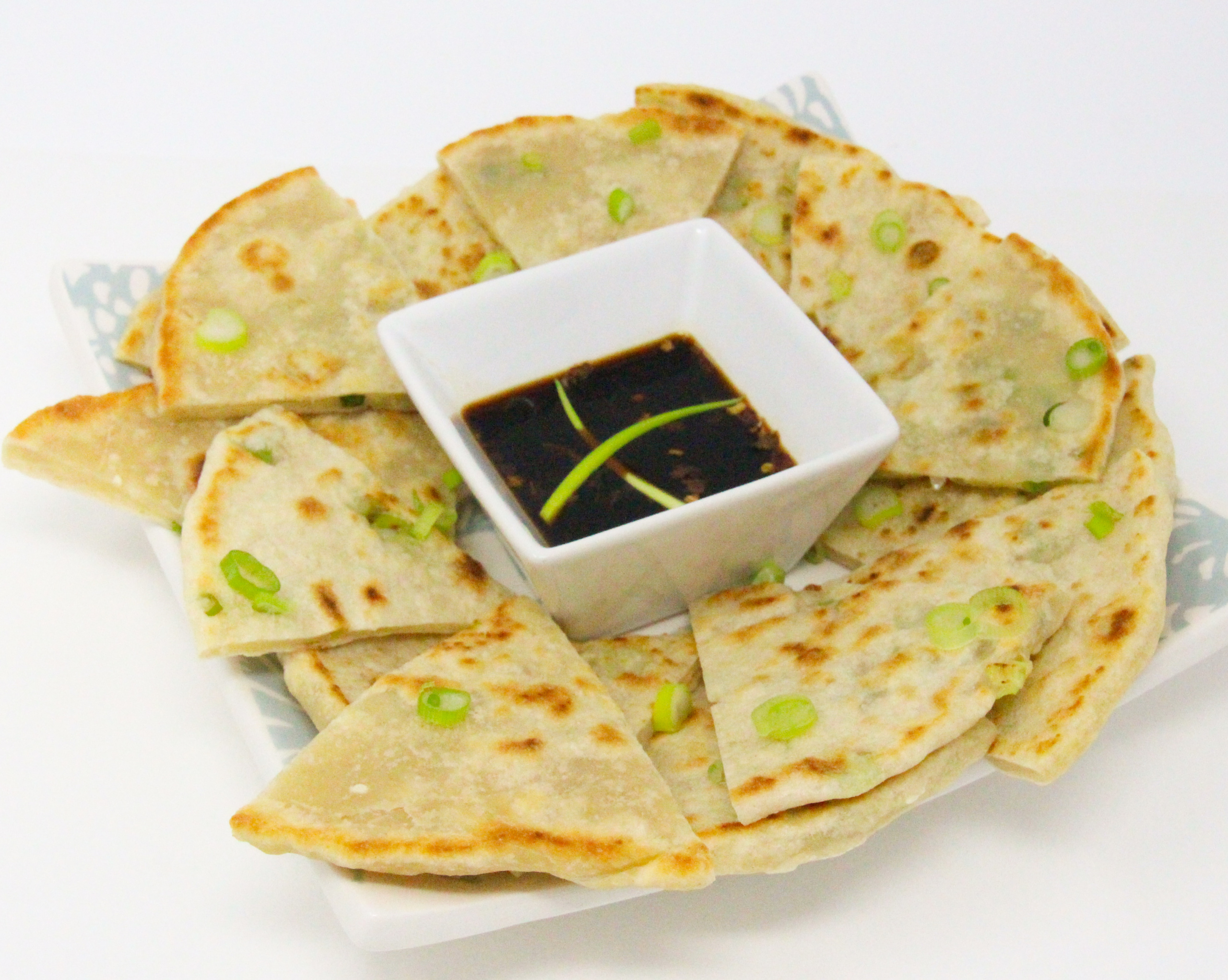 A few super simple ingredients and a hot skillet are all that's necessary to whip up delicious Scallion Pancakes. Recipe shared with permission granted by Jennifer J. Chow, author of HOT POT MURDER. 