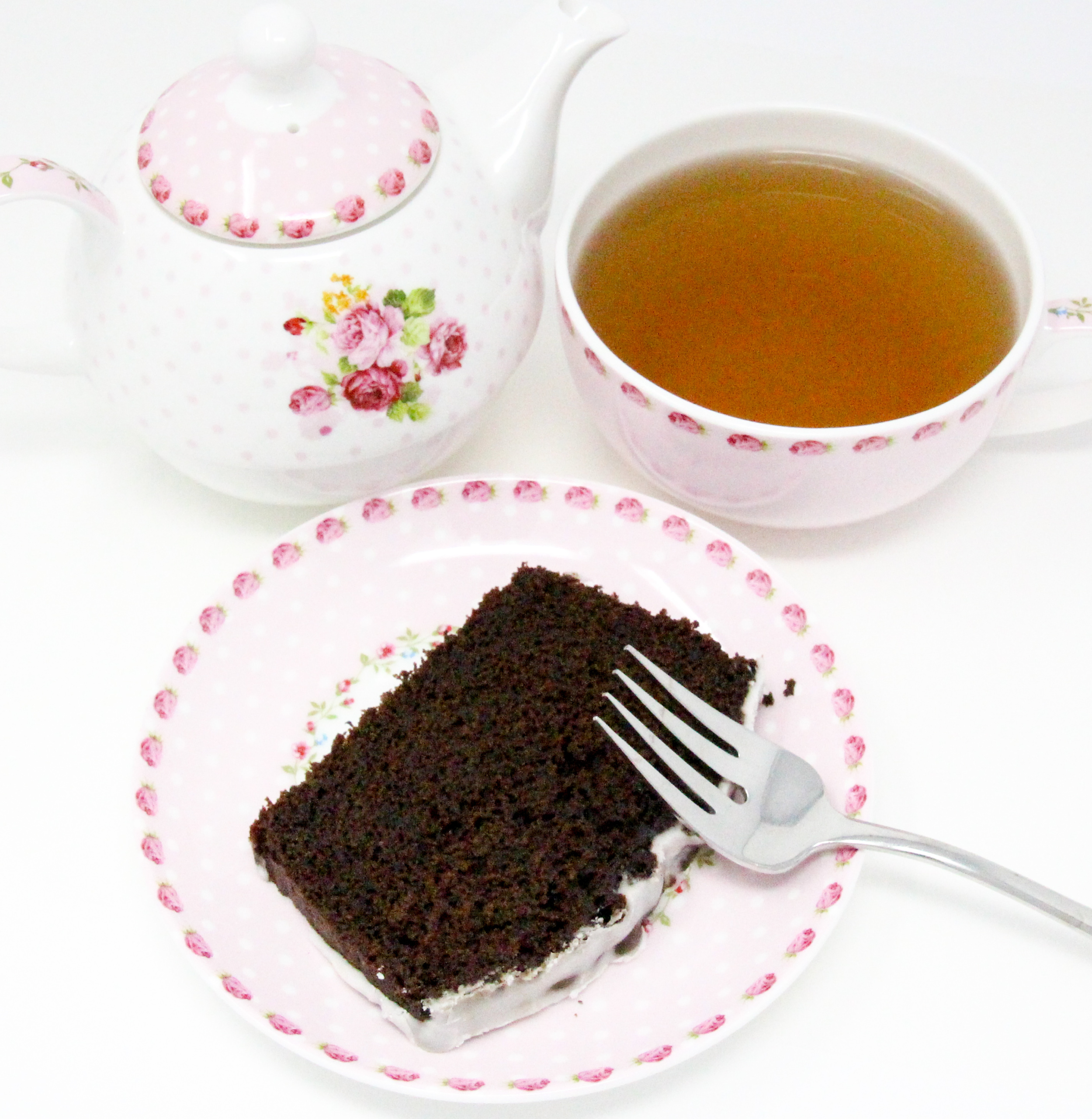 Chocolate Loaf Cake with Vanilla Drizzle has a moist crumb with a yummy chocolate flavor topped with vanilla glaze. On its own or served with ice cream, this loaf cake is a delicious way to end a meal or enjoy as a snack. Recipe shared with permission granted by Lucy Burdette, author of A CLUE IN THE CRUMBS.