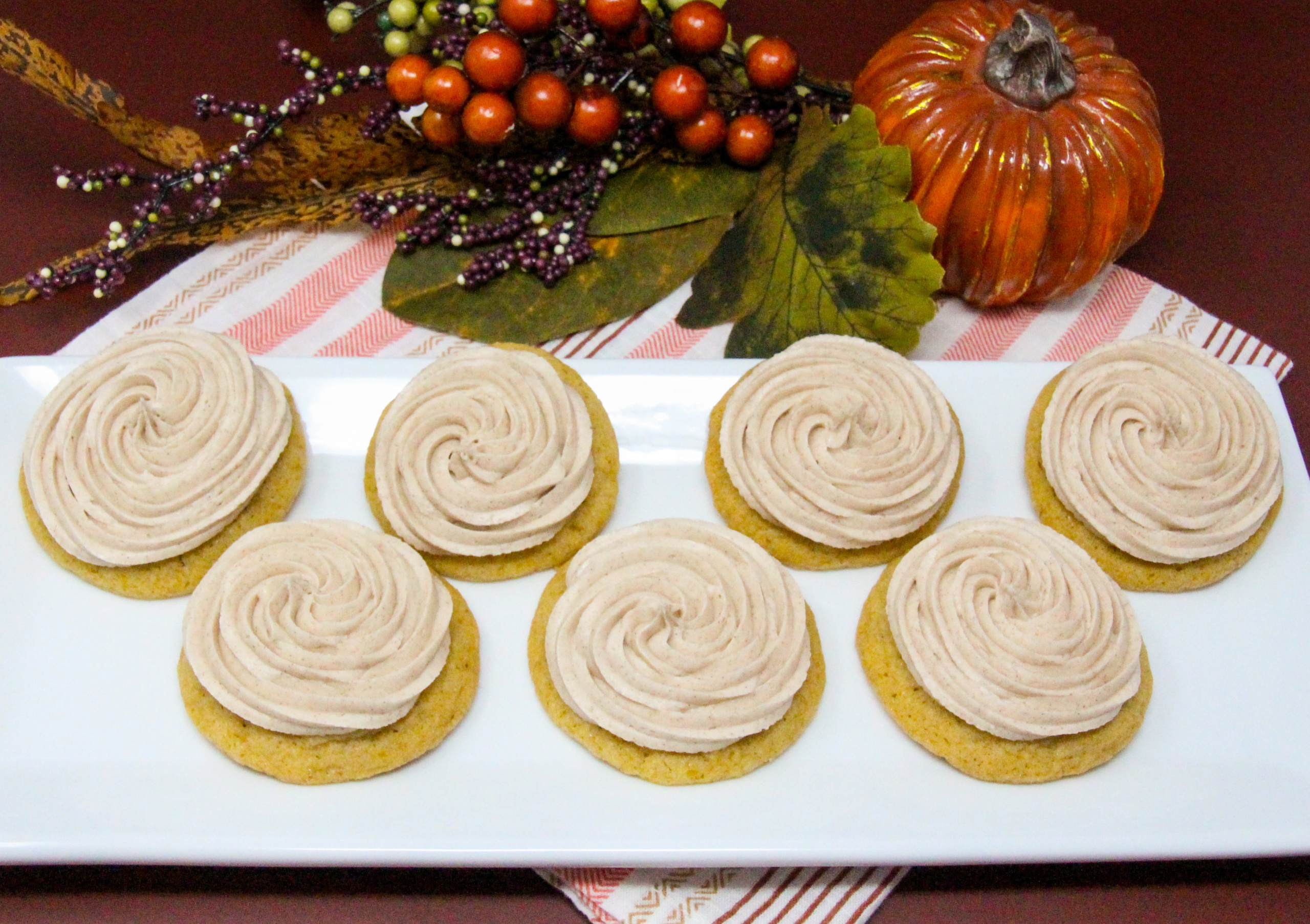 Fabulous Frosted Pumpkin Sugar Cookies are soft on the inside, a bit crunchy on the outside, and are delicious all on their own. But it’s the addition of the cinnamon-flavored frosting that makes these an extra-special treat! Recipe shared with permission granted by Darci Hannah, author of MURDER AT THE PUMPKIN PAGEANT. 