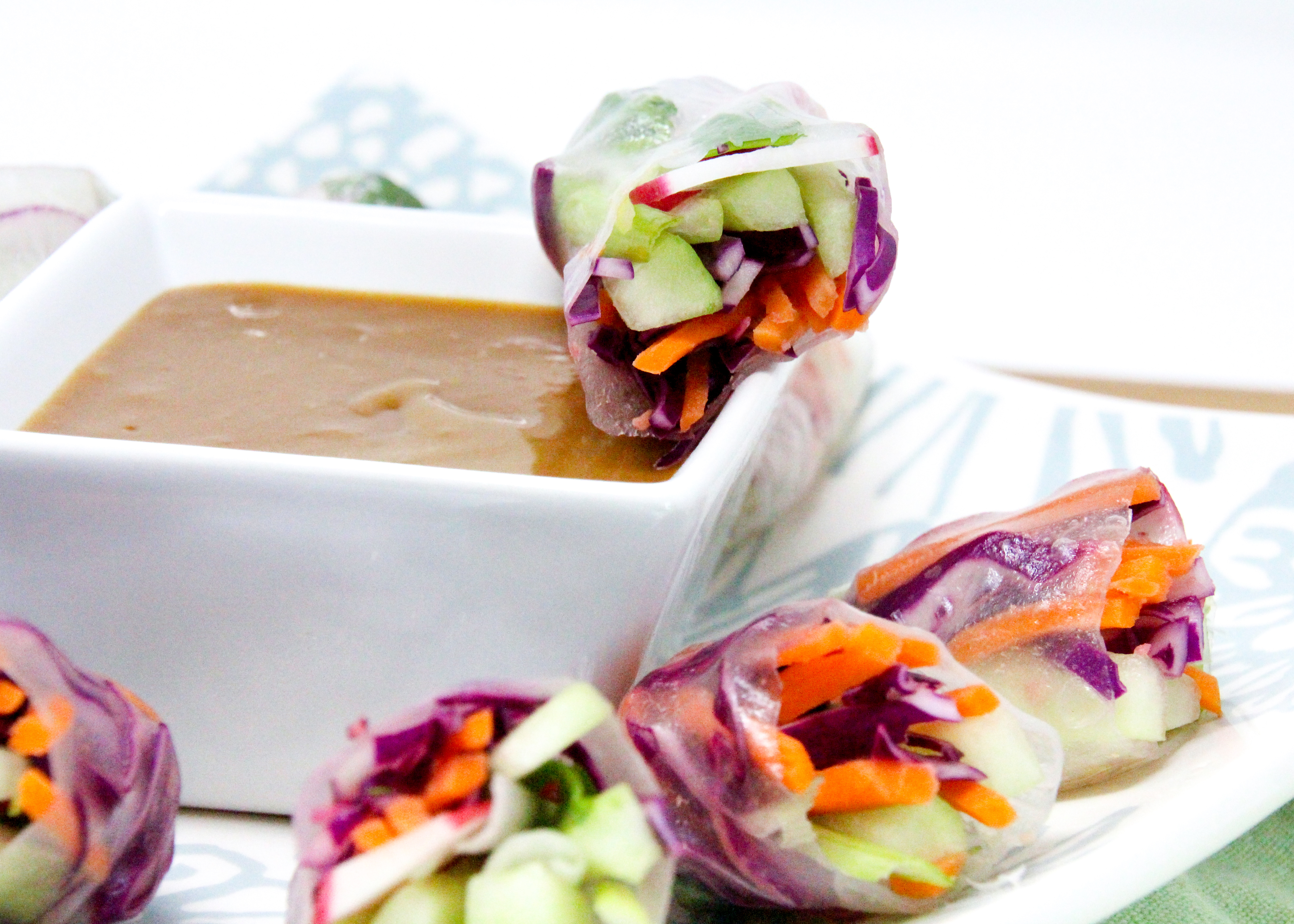 Vegetarian Spring Rolls with a Thai-inspired peanut butter dipping sauce is a delicious no-cook appetizer or side dish! Recipe shared with permission granted by Maddie Day, author of MURDER AT A CAPE BOOK STORE. 