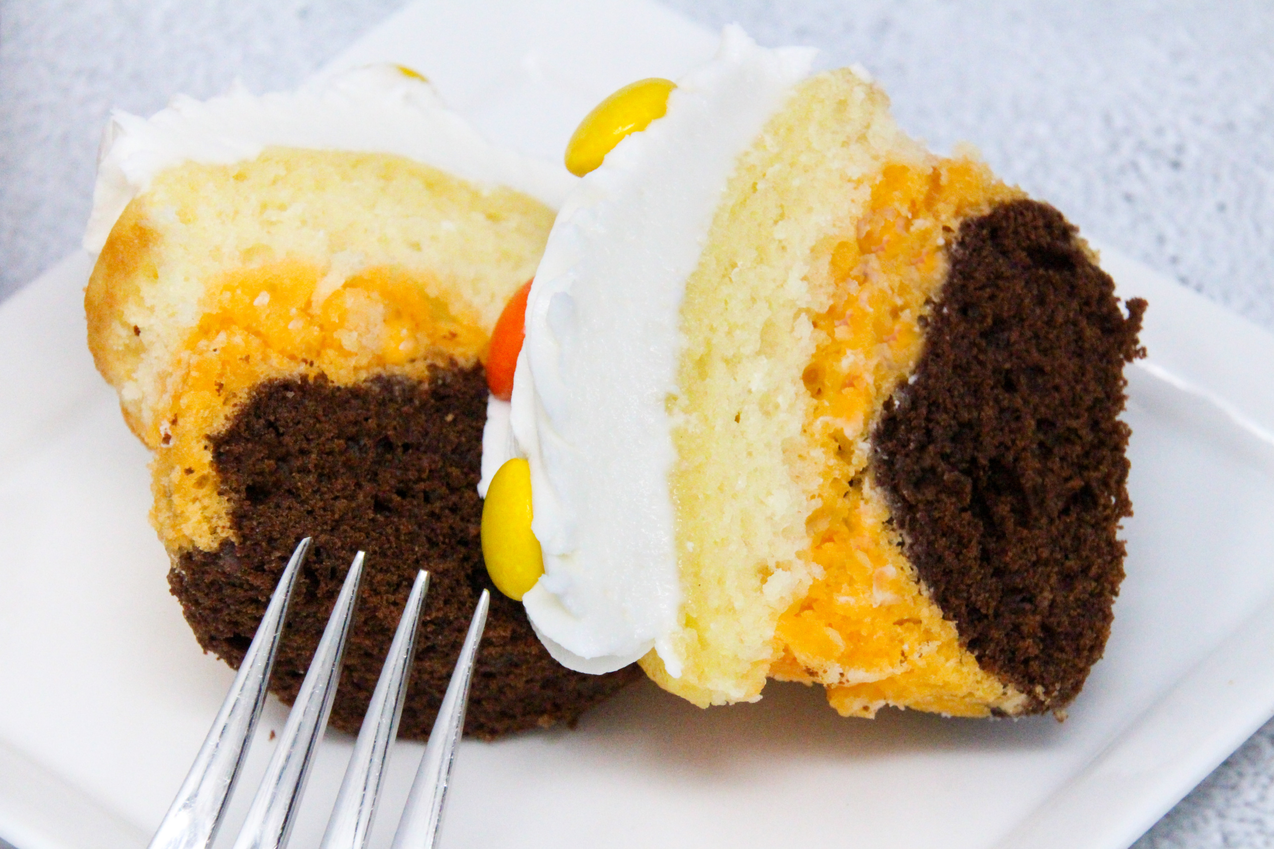 Triple-Layer Halloween Cupcakes is quick and easy, with a delicious combination of chocolate and orange flavors. With simple Reese’s Pieces used to decorate in orange and brown Halloween colors, these cupcakes will be sure to please your ghosts and ghouls! Recipe shared with permission granted by Carol J. Perry, author of A TRIPLE-LAYER HALLOWEEN MURDER.