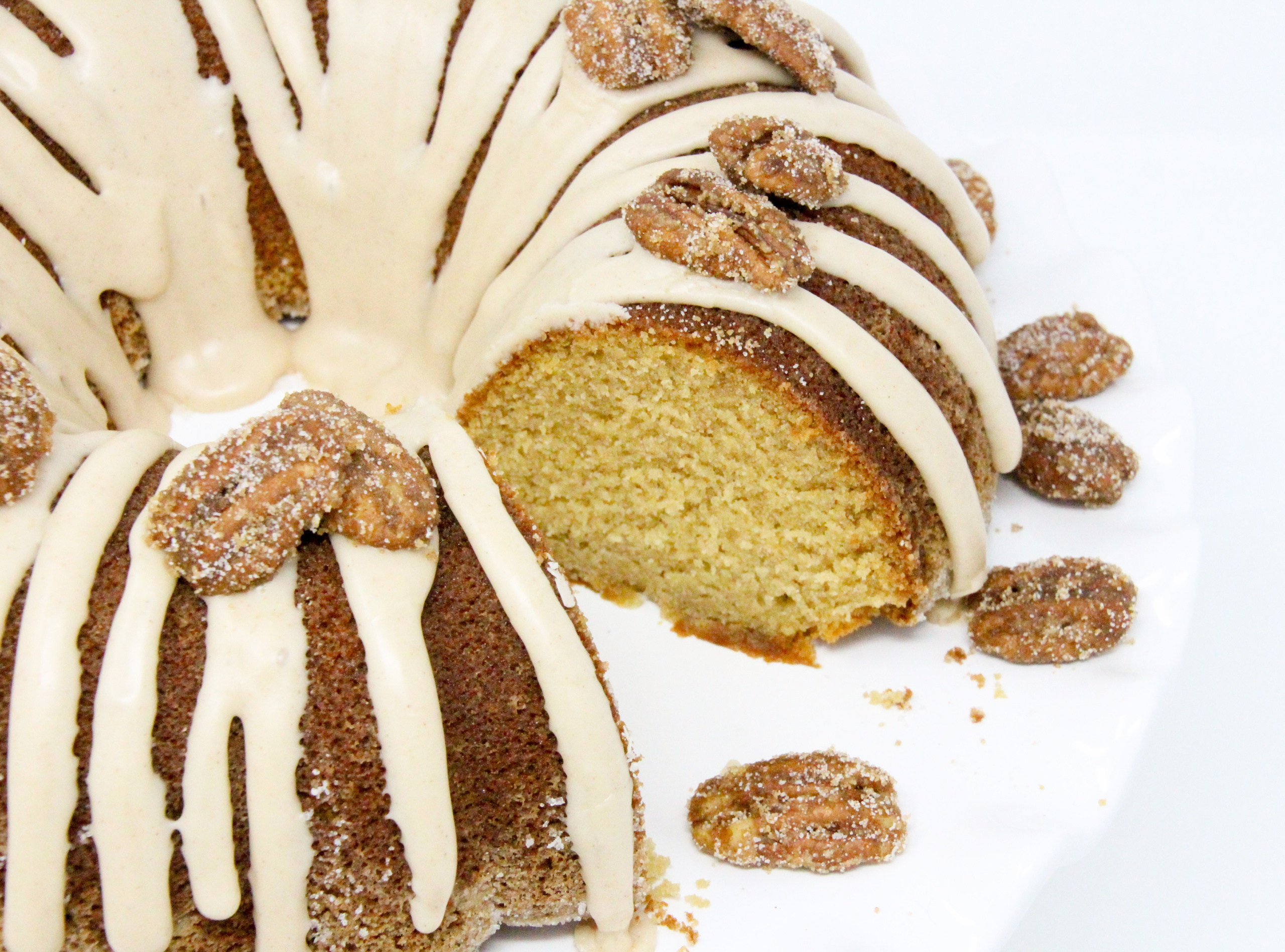 Maple Bundt cake with maple cinnamon glaze and candied pecans is a moist cake with caramel-y maple flavor. Paired with maple cinnamon glaze and candied pecans, this dessert becomes company-worthy! Recipe created by Cinnamon & Sugar for Catherine Bruns, author of SYRUP TO NO GOOD. 