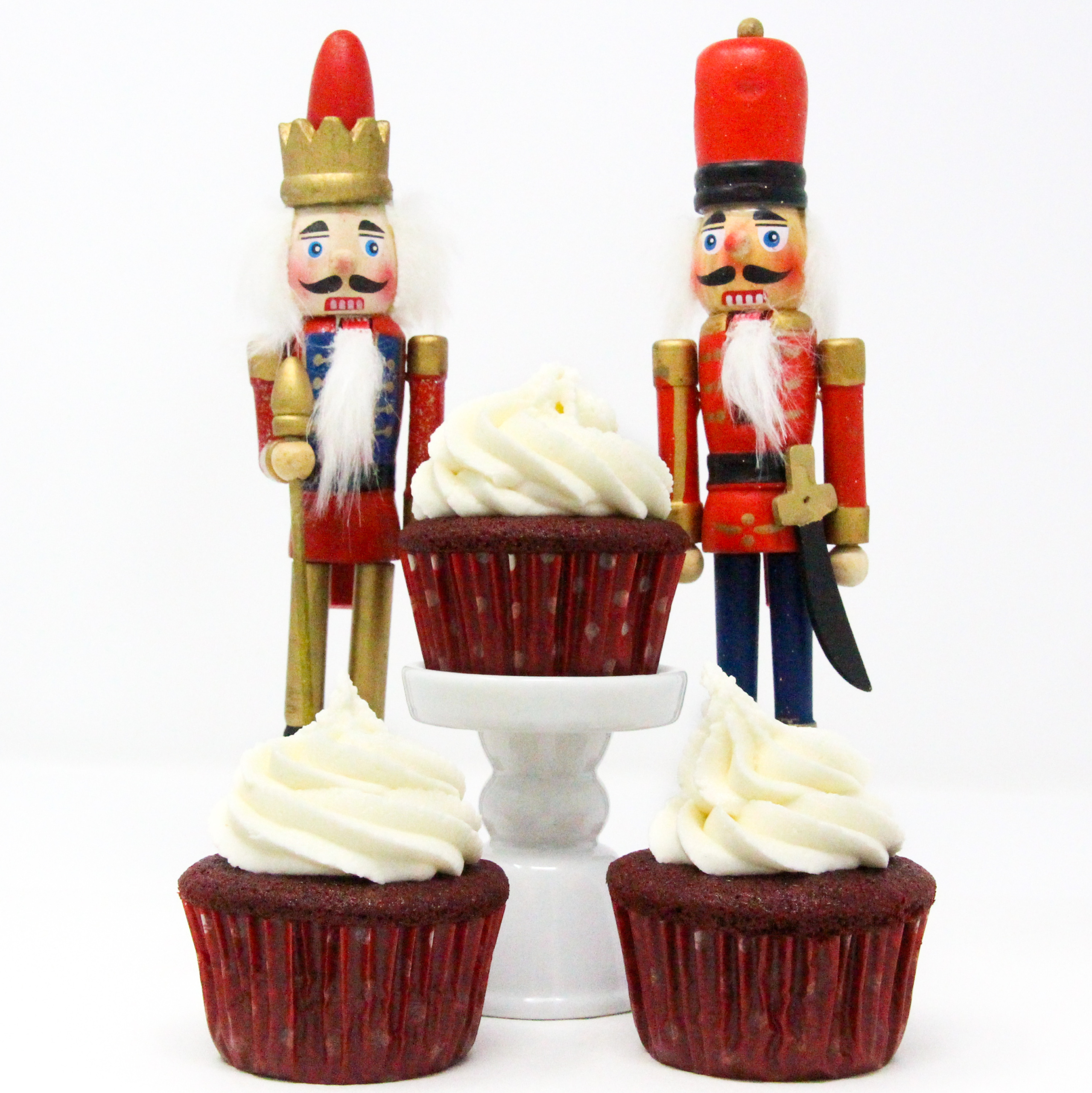 These red velvet cupcakes contain the perfect amount of chocolate and when topped with mounds of sweet buttercream frosting, the results are pure yumminess, making them a delicious way to celebrate the holidays! Recipe shared with permission granted by Christina Romeril, author of A NUTCRACKER NIGHTMARE. 
