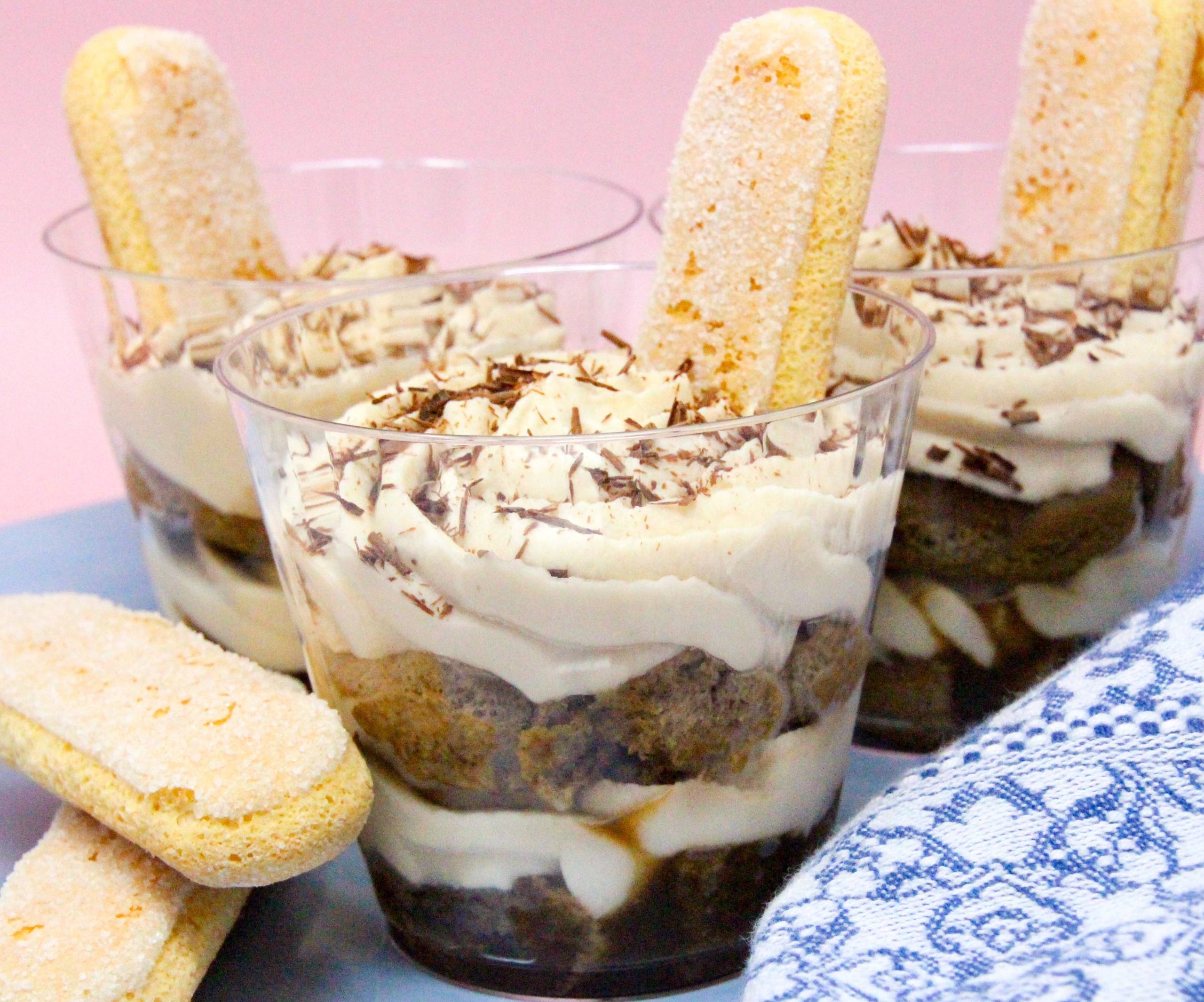 With yummy layers of coffee-dipped ladyfingers, Kahlúa-flavored mascarpone cheese, and whipped cream, your guests will be wowed by these mini Tiramisu Parfaits! Recipe shared with permission granted by Maya Corrigan, author of A PARFAIT CRIME. 