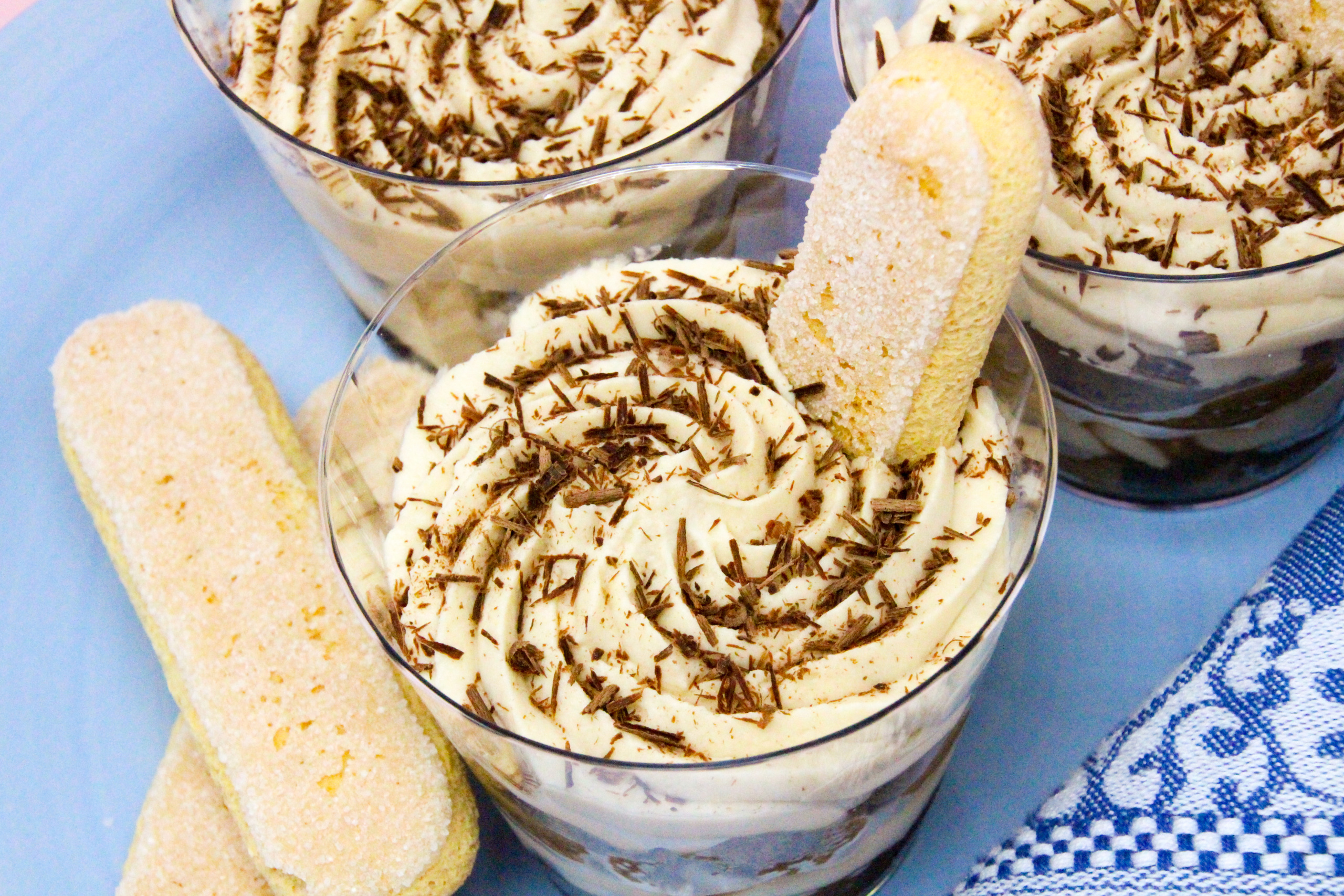 With yummy layers of coffee-dipped ladyfingers, Kahlúa-flavored mascarpone cheese, and whipped cream, your guests will be wowed by these mini Tiramisu Parfaits! Recipe shared with permission granted by Maya Corrigan, author of A PARFAIT CRIME. 