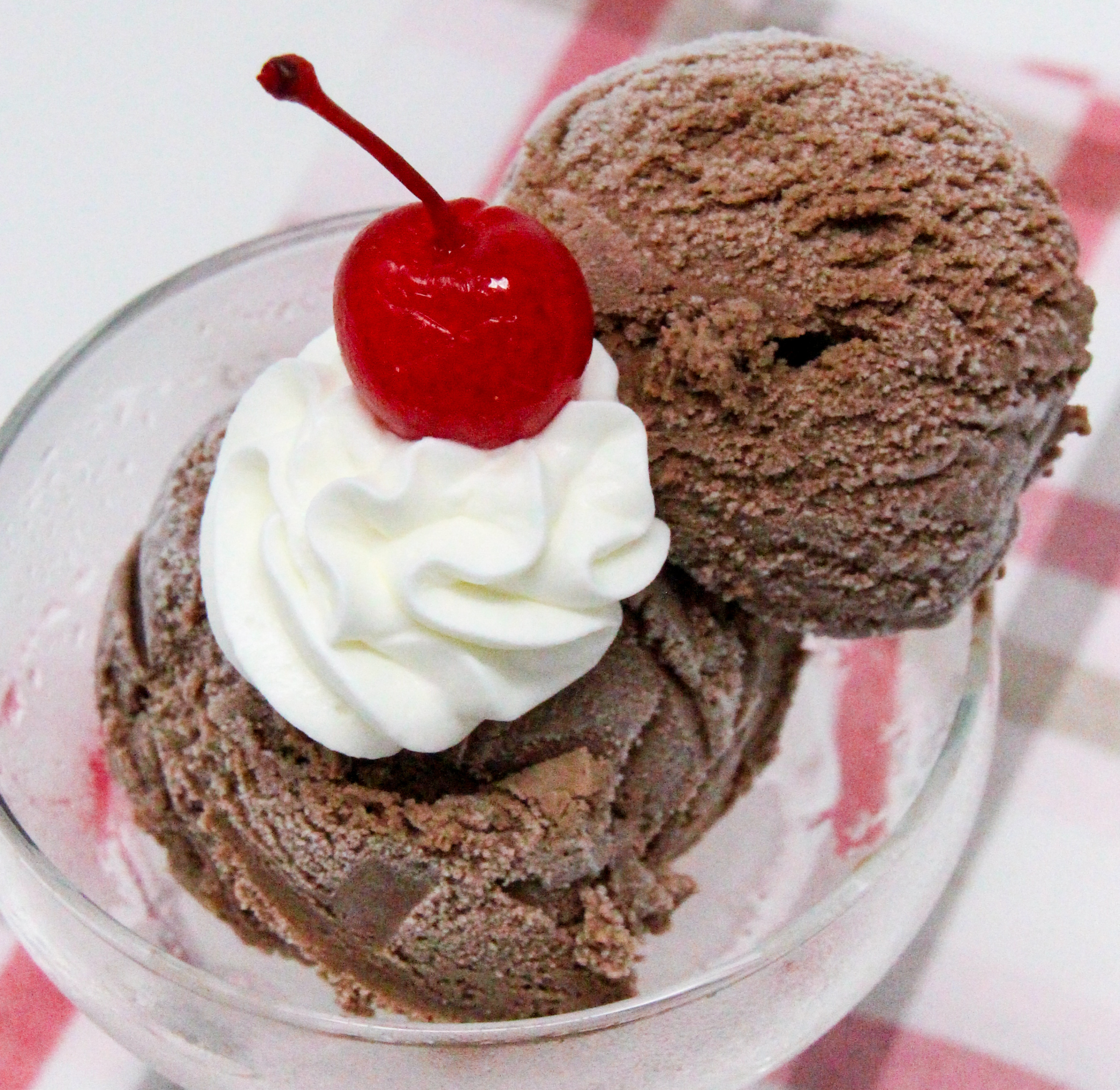 Shortcut Hot Cocoa Ice Cream uses four simple ingredients and the no-cook recipe mixes up quickly. After a quick fifteen-minute churn in an ice cream maker, the yummy chocolaty soft serve ice cream is ready to eat. Recipe shared with permission granted by the publisher, Sourcebooks / Poisoned Pen Press. 