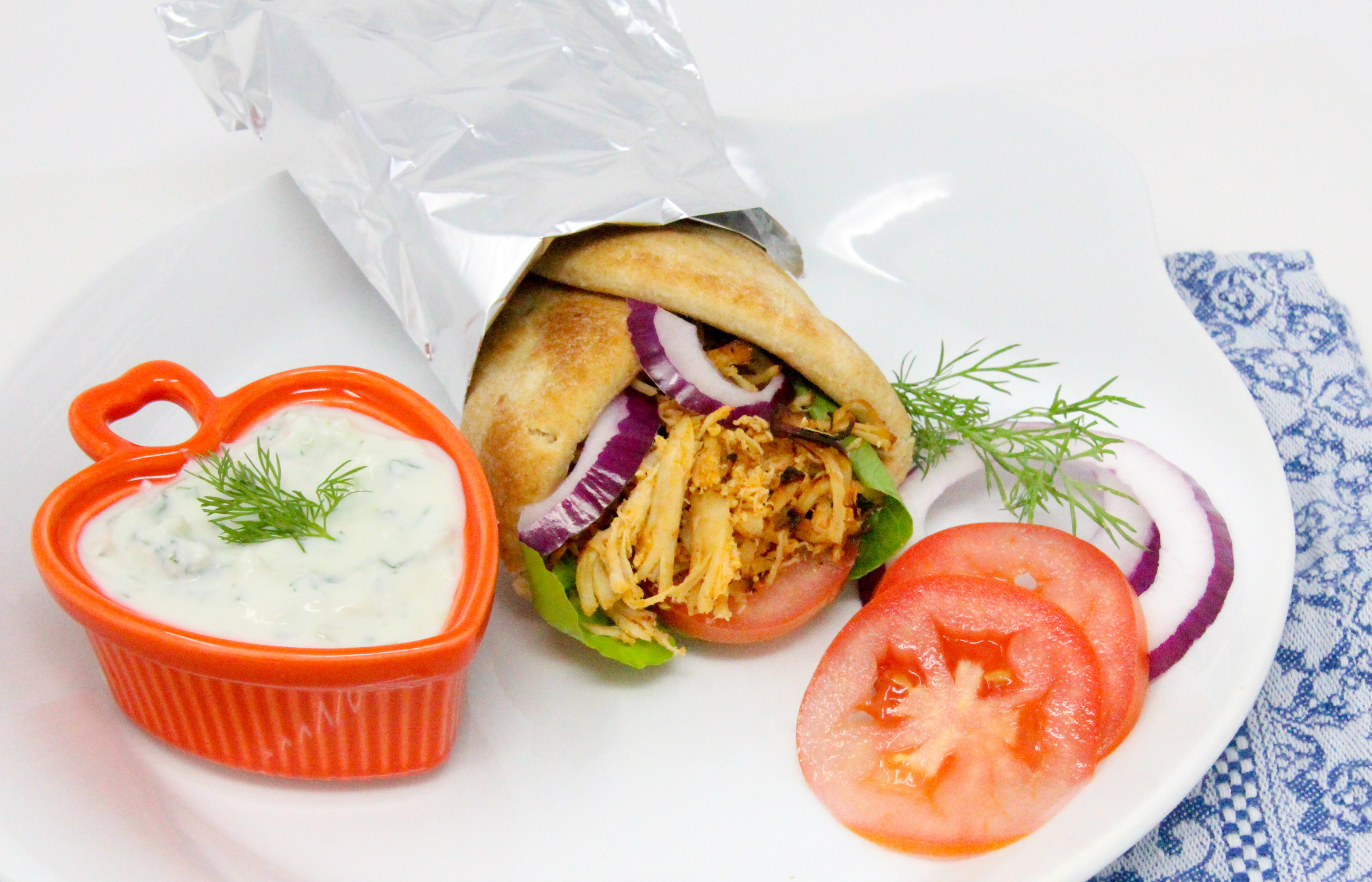Chicken Gyros with Tzatziki Sauce uses pre-cooked chicken breast which makes this meal comes together quickly. Recipe shared with permission granted by Lynn Cahoon, author of FIVE FURRY FAMILIARS.