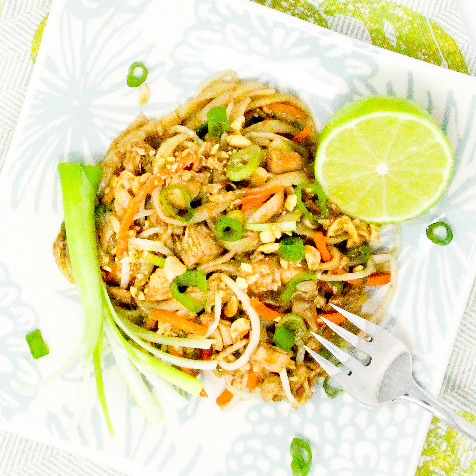 Chicken Pad Thai combines a spicy sweet sauce with rice noodles (making this dish naturally gluten-free), while the crunch of the veggies and roasted peanuts add a pleasing texture. Recipe shared with permission granted by Maddie Day, author of MURDER AT THE RUSTY ANCHOR. 
