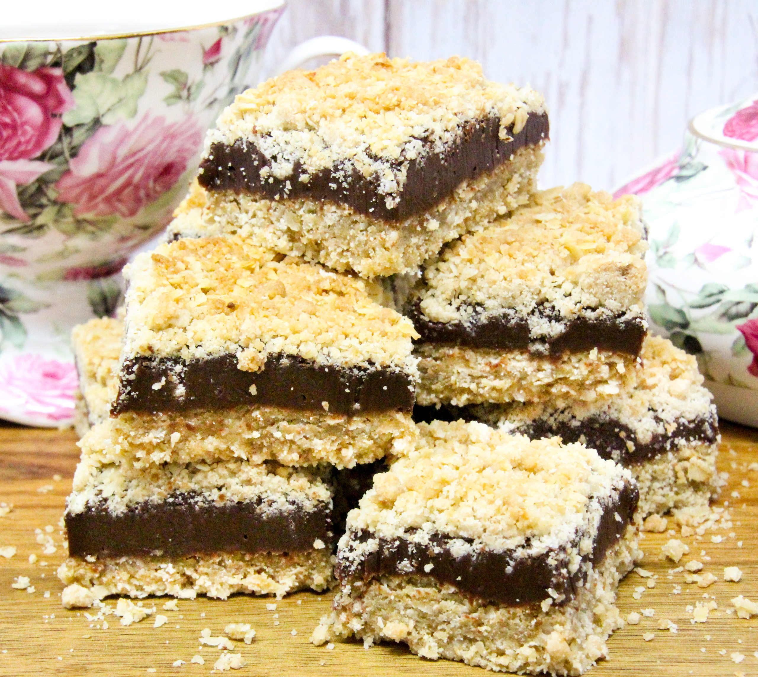 Fudgy Oatmeal Bars are a substantial treat with the addition of oatmeal which offsets (kind of) the sugar high from the rich, fudgy center. Recipe shared with permission granted by Nancy J. Coco, author of THREE FUDGES AND A BABY. 