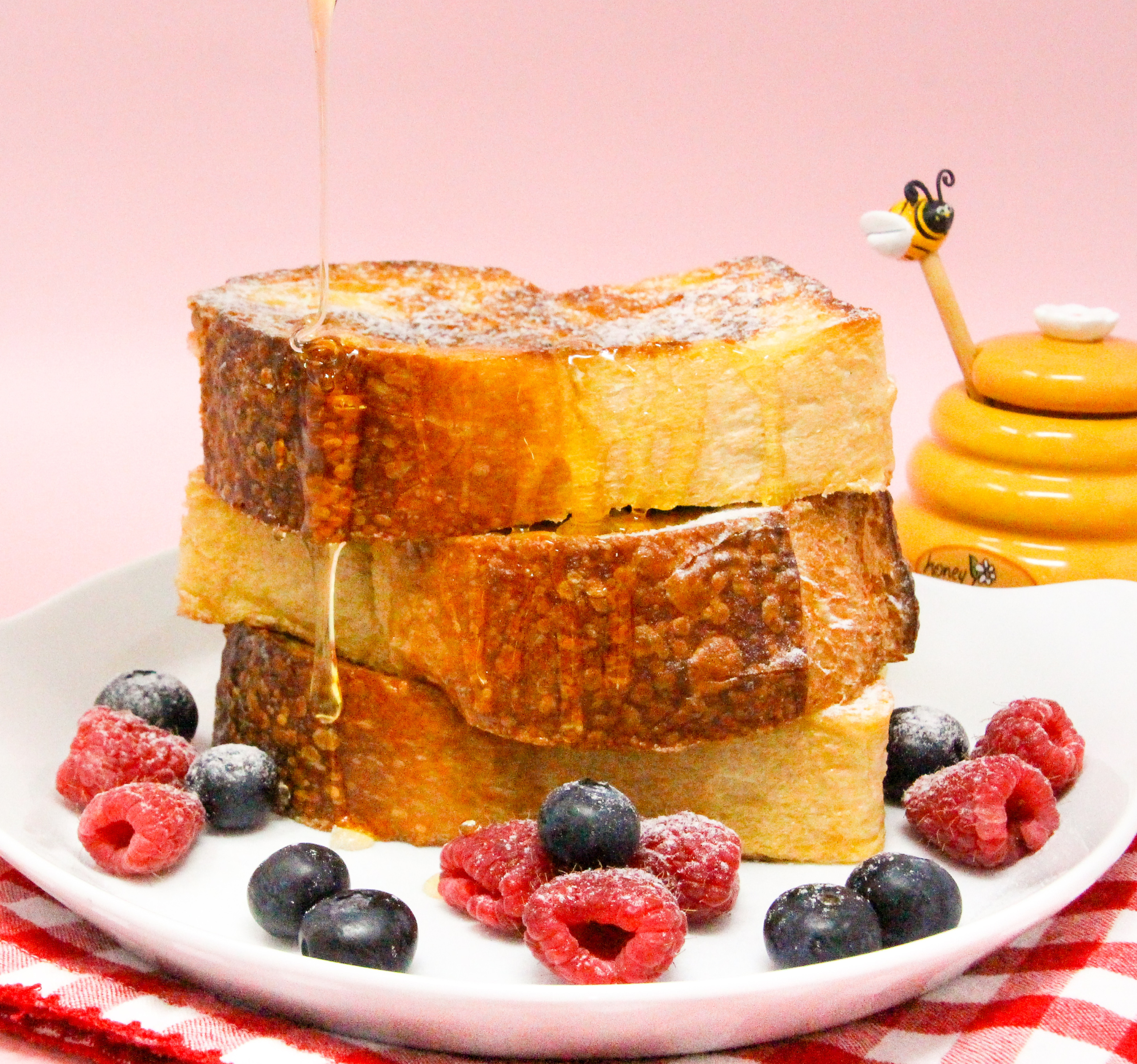 Honey-Ricotta-Stuffed French Toast starts with thick slabs of French bread then stuffed with a ricotta-based filling lightly sweetened with honey and a liberal amount of lemon zest for a tart tang. Recipe shared with permission granted by Jennie Marts, author of KILL OR BEE KILLED. 