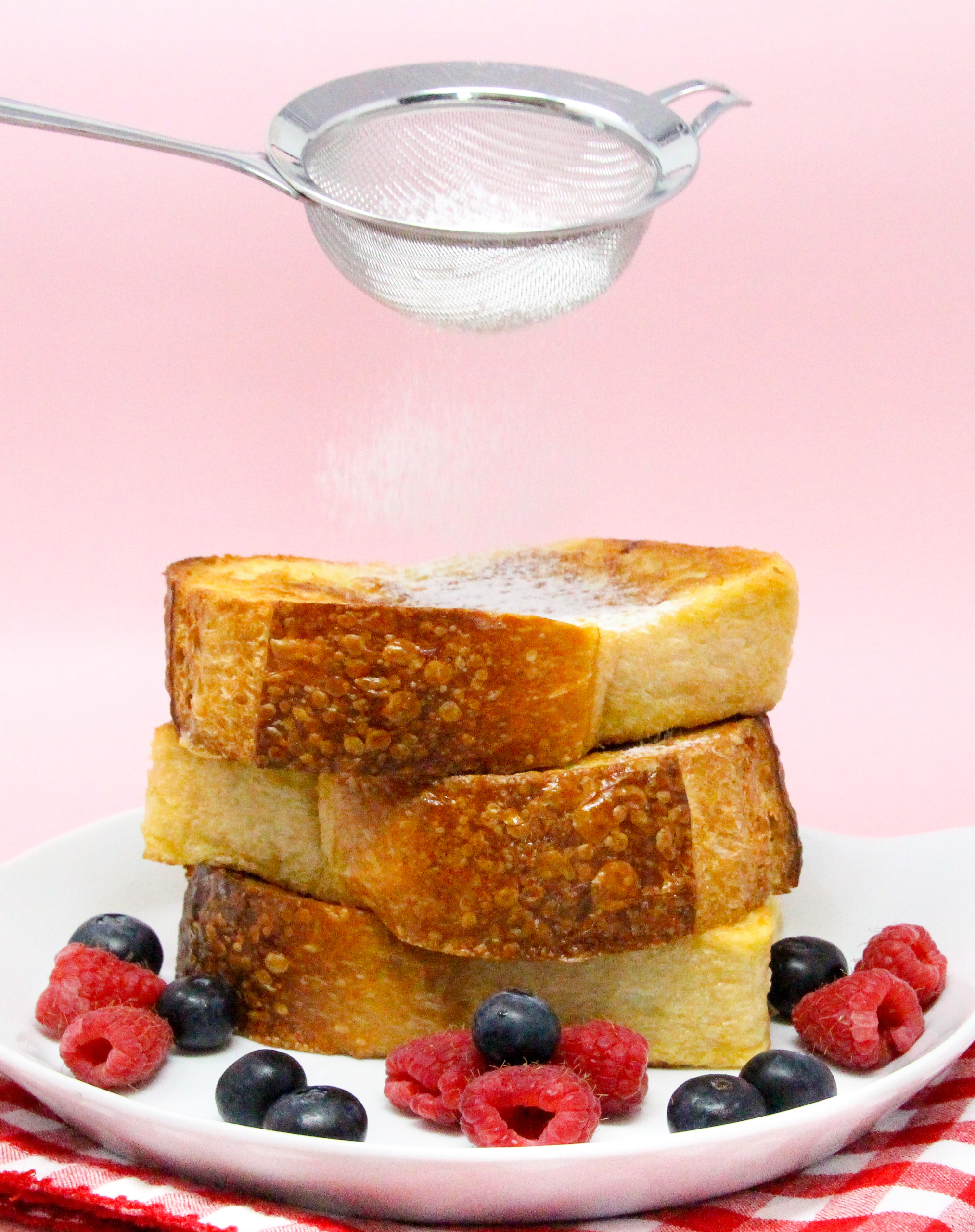 Honey-Ricotta-Stuffed French Toast starts with thick slabs of French bread then stuffed with a ricotta-based filling lightly sweetened with honey and a liberal amount of lemon zest for a tart tang. Recipe shared with permission granted by Jennie Marts, author of KILL OR BEE KILLED. 
