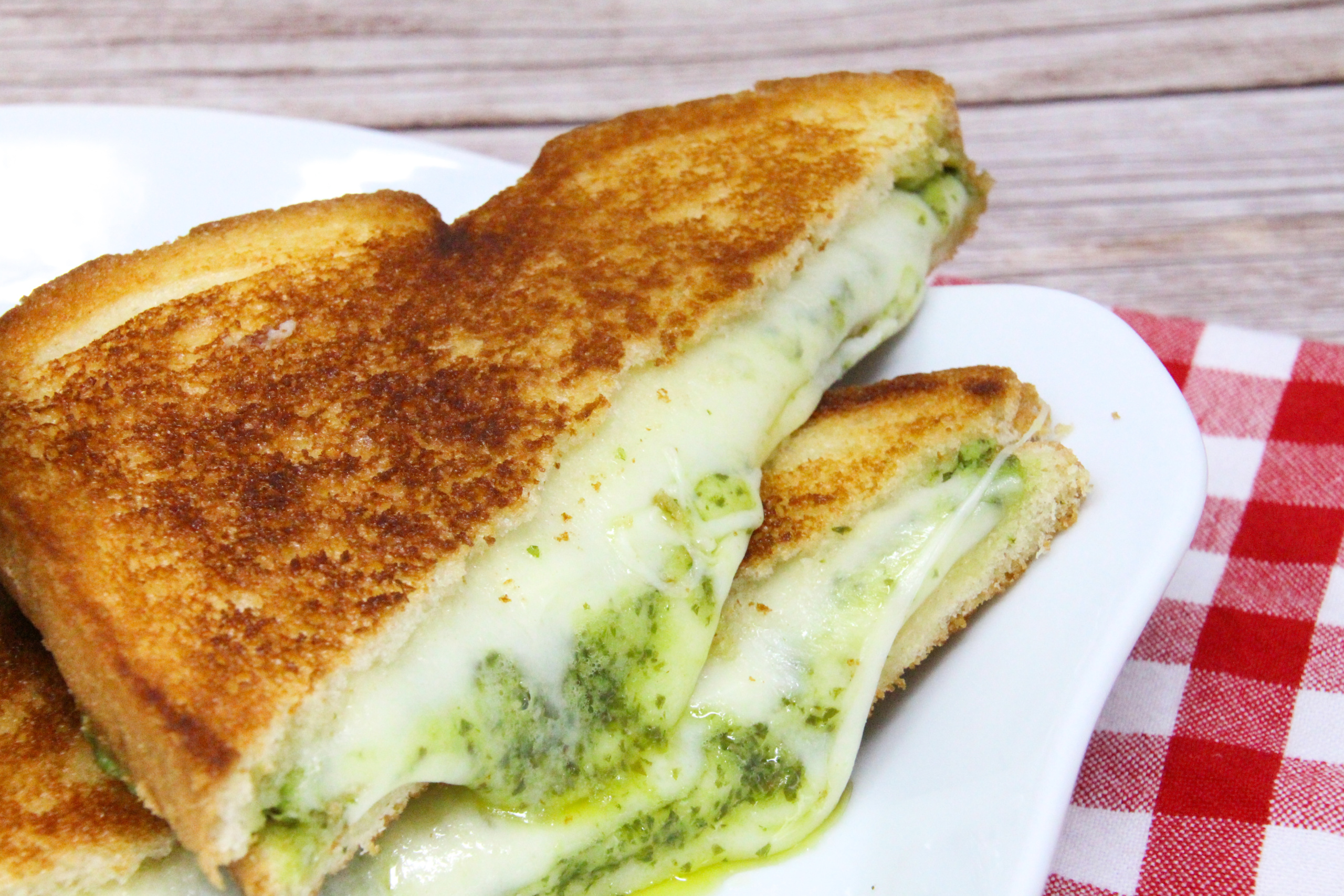 Zesty Pesto Grilled Cheese Sandwich pairs pesto with creamy provolone while the crunchy exterior of the bread provides a nice contrast. Eaten on its own or with Grant’s Tomato Soup, this sandwich is a flavorful delight! Recipe shared with permission granted by Linda Reilly, author of BRIE CAREFUL WHAT YOU WISH FOR. 