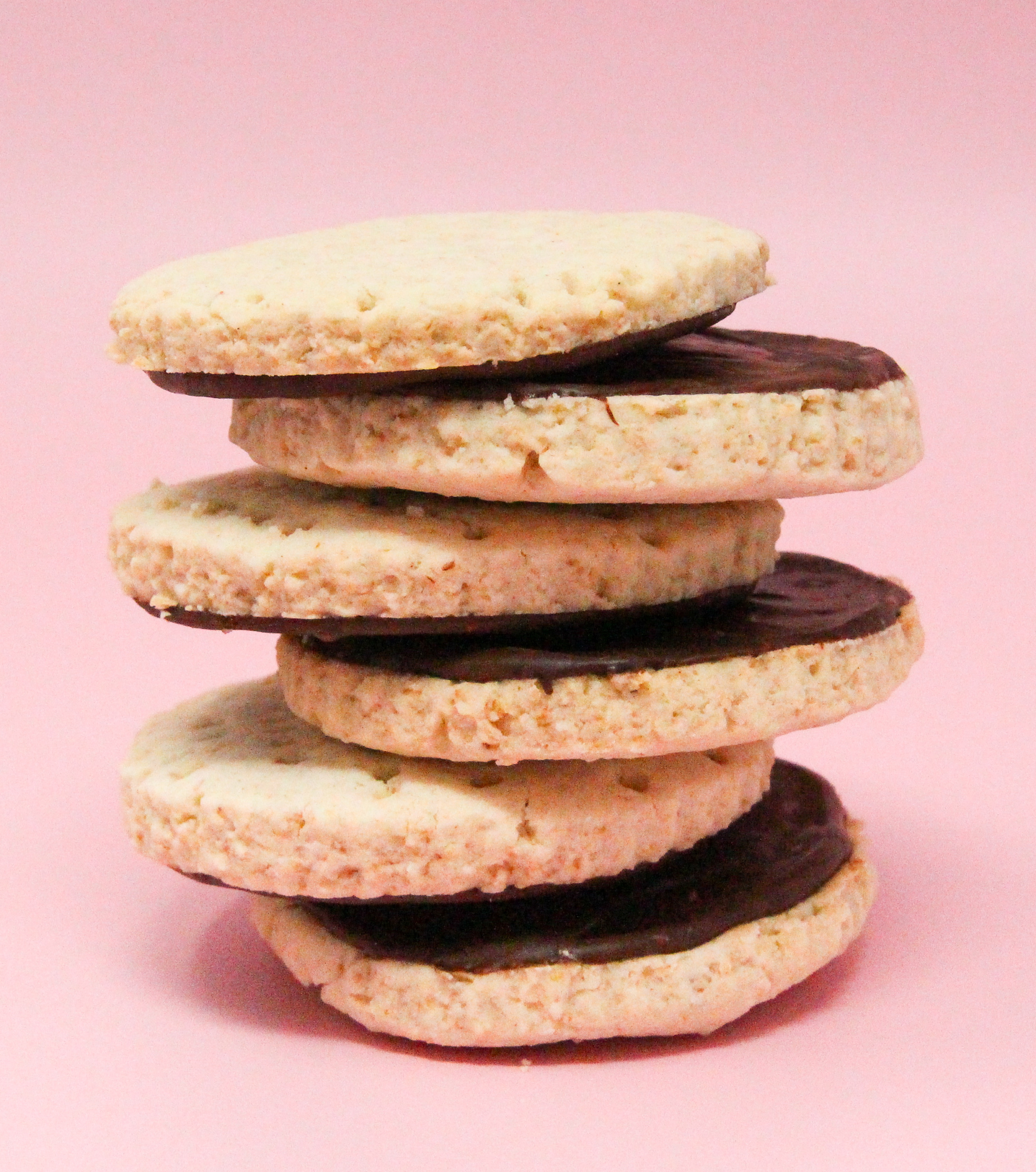 Bunny's Chocolate Digestive Biscuits are a British teatime treat! Oatmeal based, the nice chewy texture is enhanced with the addition of chocolate. Recipe shared with permission granted by Darci Hannah, author of A FATAL FEAST AT BRAMSFORD MANOR. 