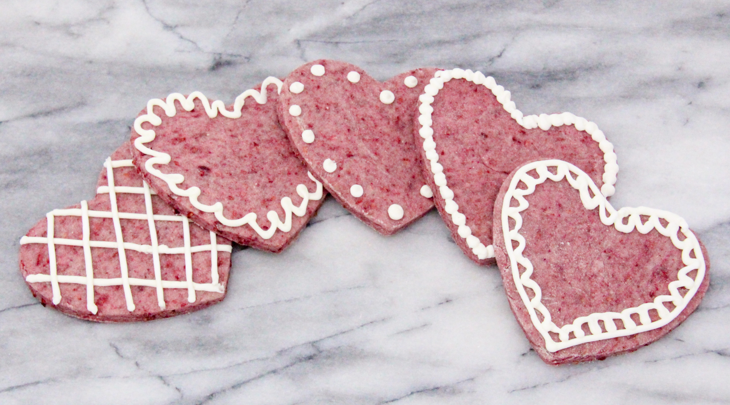 Raspberry Sugar Cookies rely on freeze-dried raspberries to provide a tart sweetness along with a pretty pink color to the cookies, without relying on food coloring. Recipe created by Cinnamon & Sugar for Catherine Bruns, author of CRIMES AND CONFECTIONS.