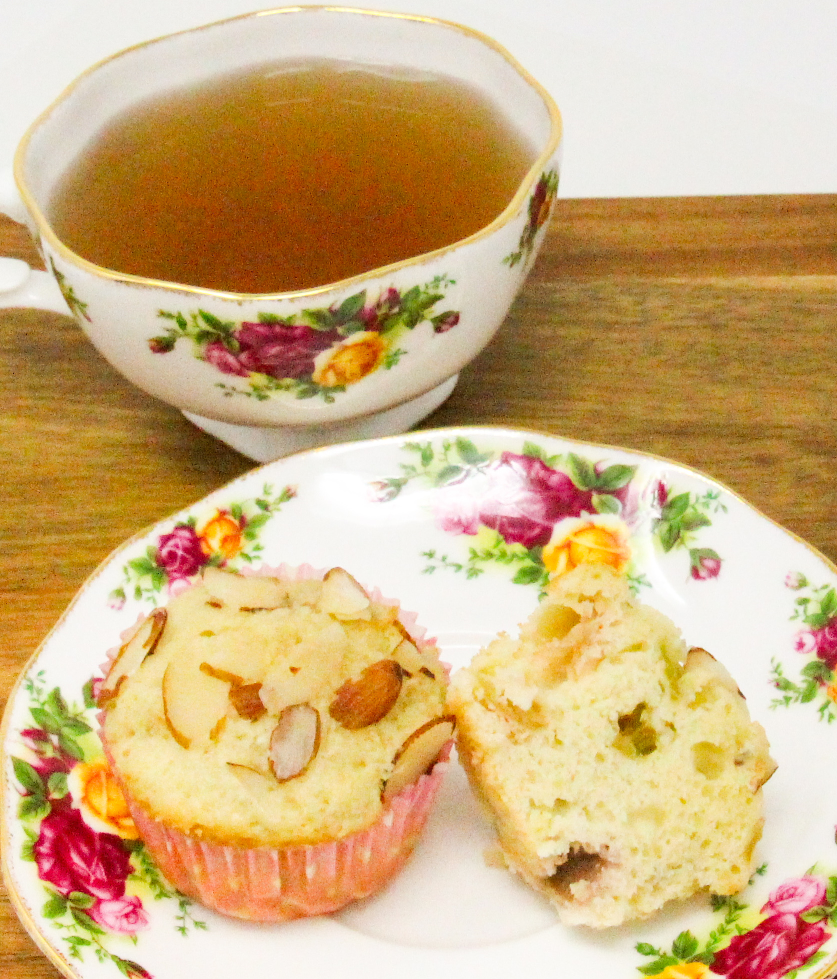 Bits of ruby red rhubarb is studded throughout these Rhubarb Almond Muffins, making them extra moist with a tart bite. Almond flavoring and sliced almonds sprinkled on top of the muffin brings a delicate flavor that complements the fruit. Recipe shared with permission granted by Leslie Budewitz, author of TO ERR IS CUMIN. 