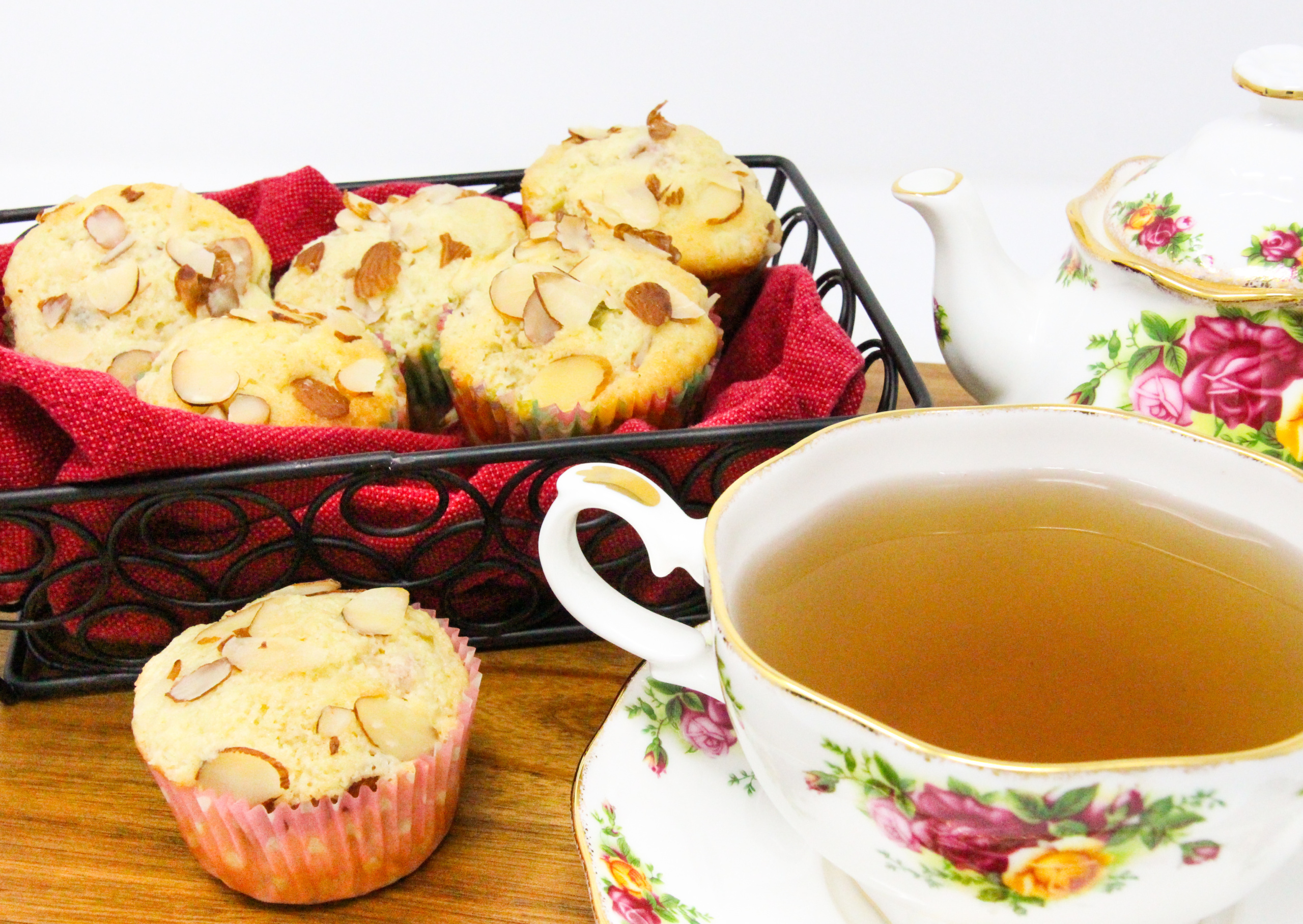 Bits of ruby red rhubarb is studded throughout these Rhubarb Almond Muffins, making them extra moist with a tart bite. Almond flavoring and sliced almonds sprinkled on top of the muffin brings a delicate flavor that complements the fruit. Recipe shared with permission granted by Leslie Budewitz, author of TO ERR IS CUMIN. 