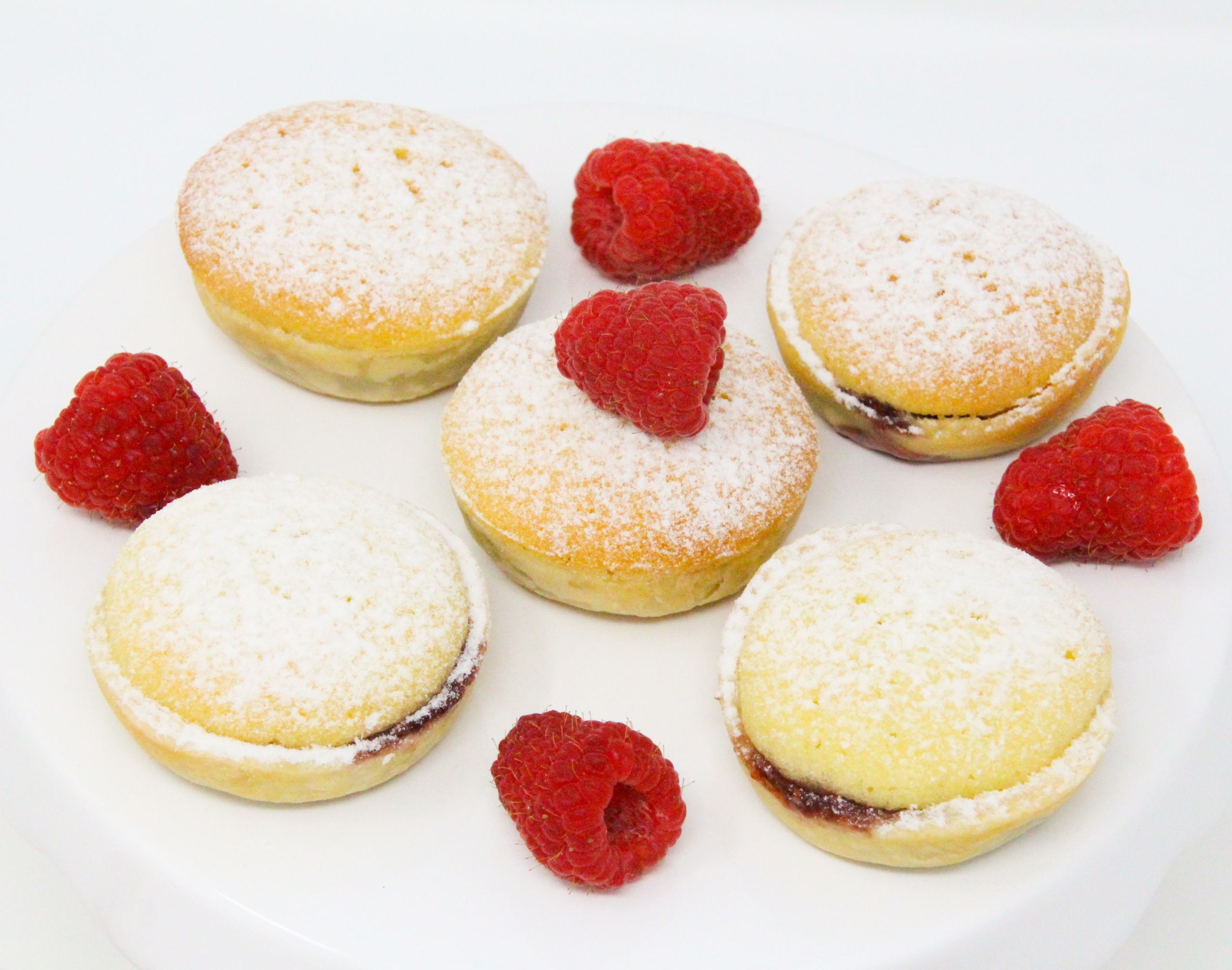 Maids of Honor are tiny tarts with a muffin-like topping and raspberry filling making these little dessert morsels a delicious and unique treat. Recipe shared with permission granted by Daryl Wood Gerber, author of MURDER ON THE PAGE. 