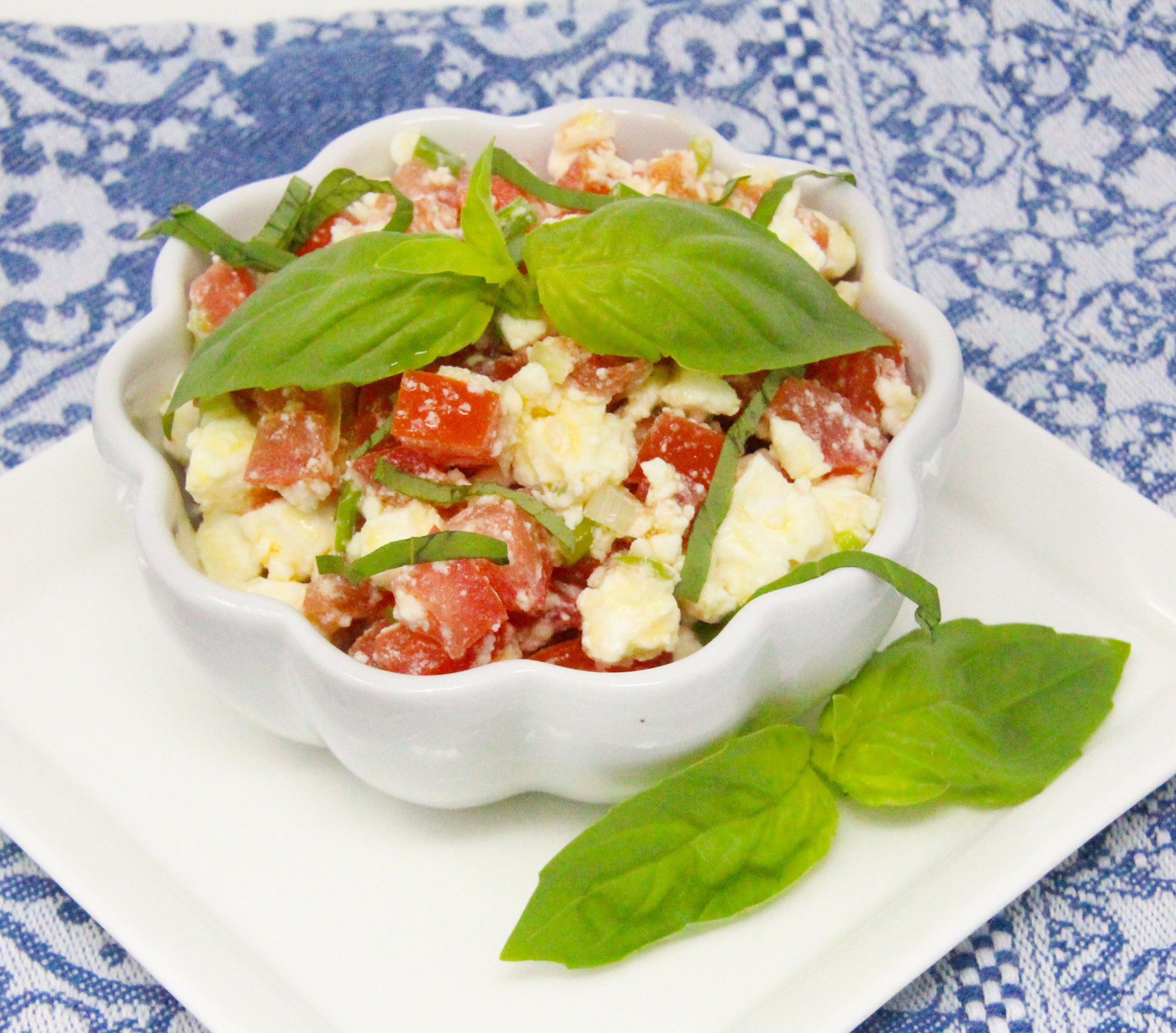 Grant's Festive Feta Appetizers combines the salty tang of feta cheese with the sweetness of firm tomatoes, mixed with fresh basil, balsamic glaze, and Greek seasoning, making for a delicious and satisfying topping to naan bread or a dip for sturdy crackers. Recipe shared with permission granted by Linda Reilly, author of YOU FETA WATCH OUT. 