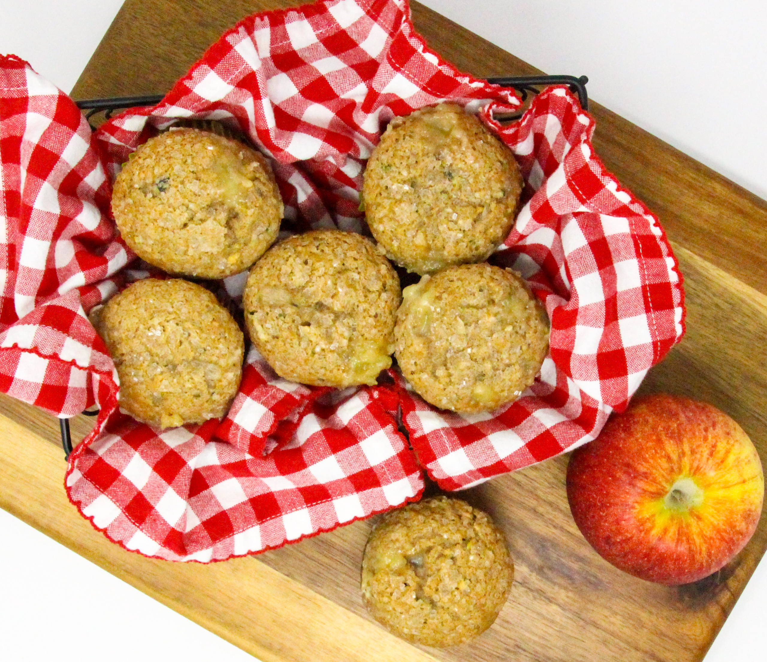 Apple Muffins with an Added Surprise are super moist, thanks to both apple and zucchini used in the batter. The cinnamon adds a nice flavor while the cream cheese filling adds richness. Recipe shared with permission granted by Lois Winston, author of SEAMS LIKE THE PERFECT CRIME.