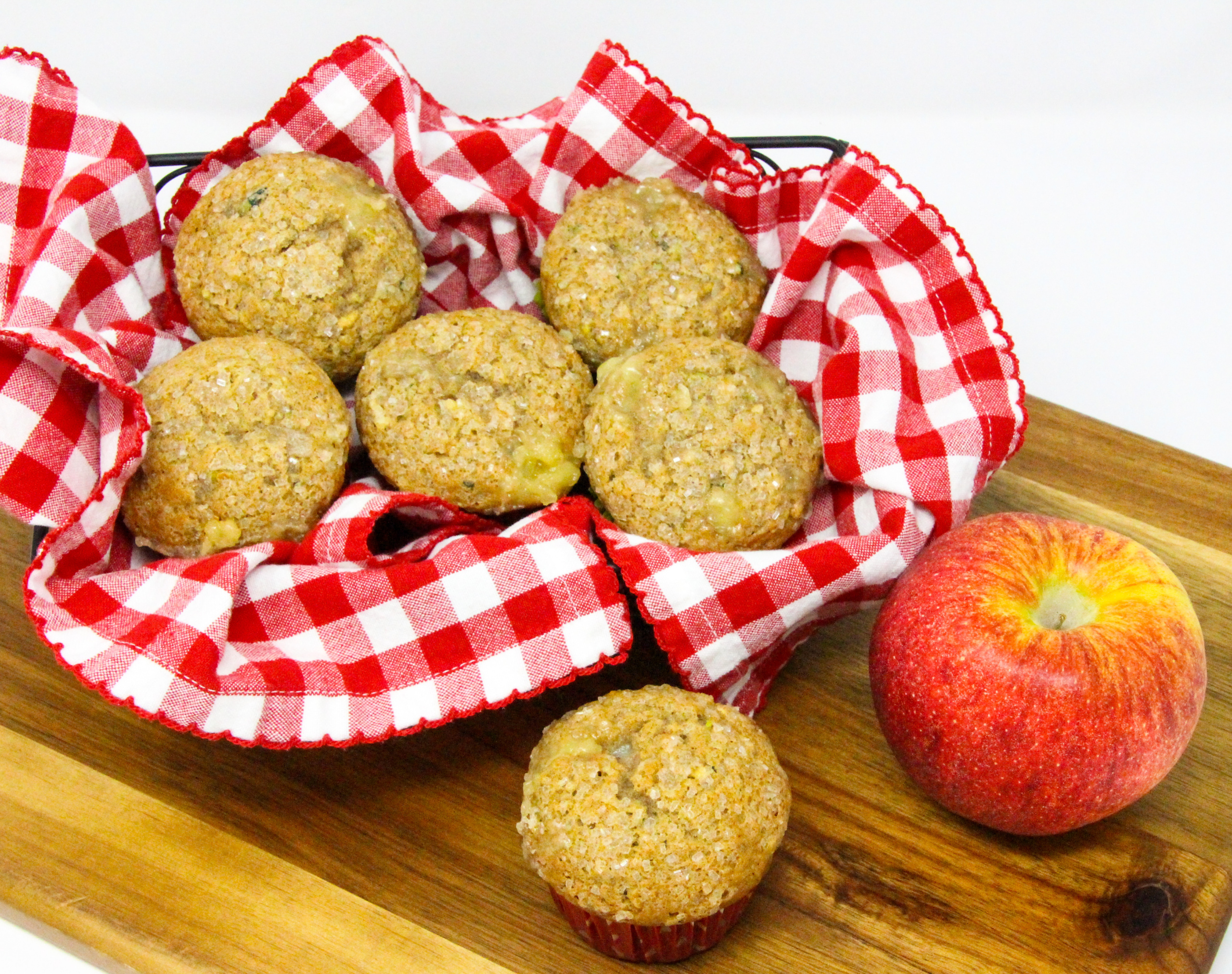 Apple Muffins with an Added Surprise are super moist, thanks to both apple and zucchini used in the batter. The cinnamon adds a nice flavor while the cream cheese filling adds richness. Recipe shared with permission granted by Lois Winston, author of SEAMS LIKE THE PERFECT CRIME.
