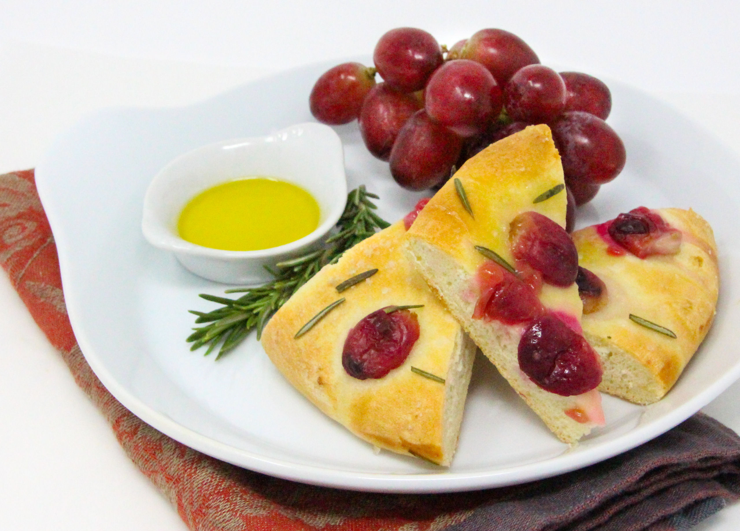 The recipe for Rustic Vineyard Grape and Rosemary Flatbread is shared with permission granted by Daisy Landish, author of WINE & WHISPERS. 