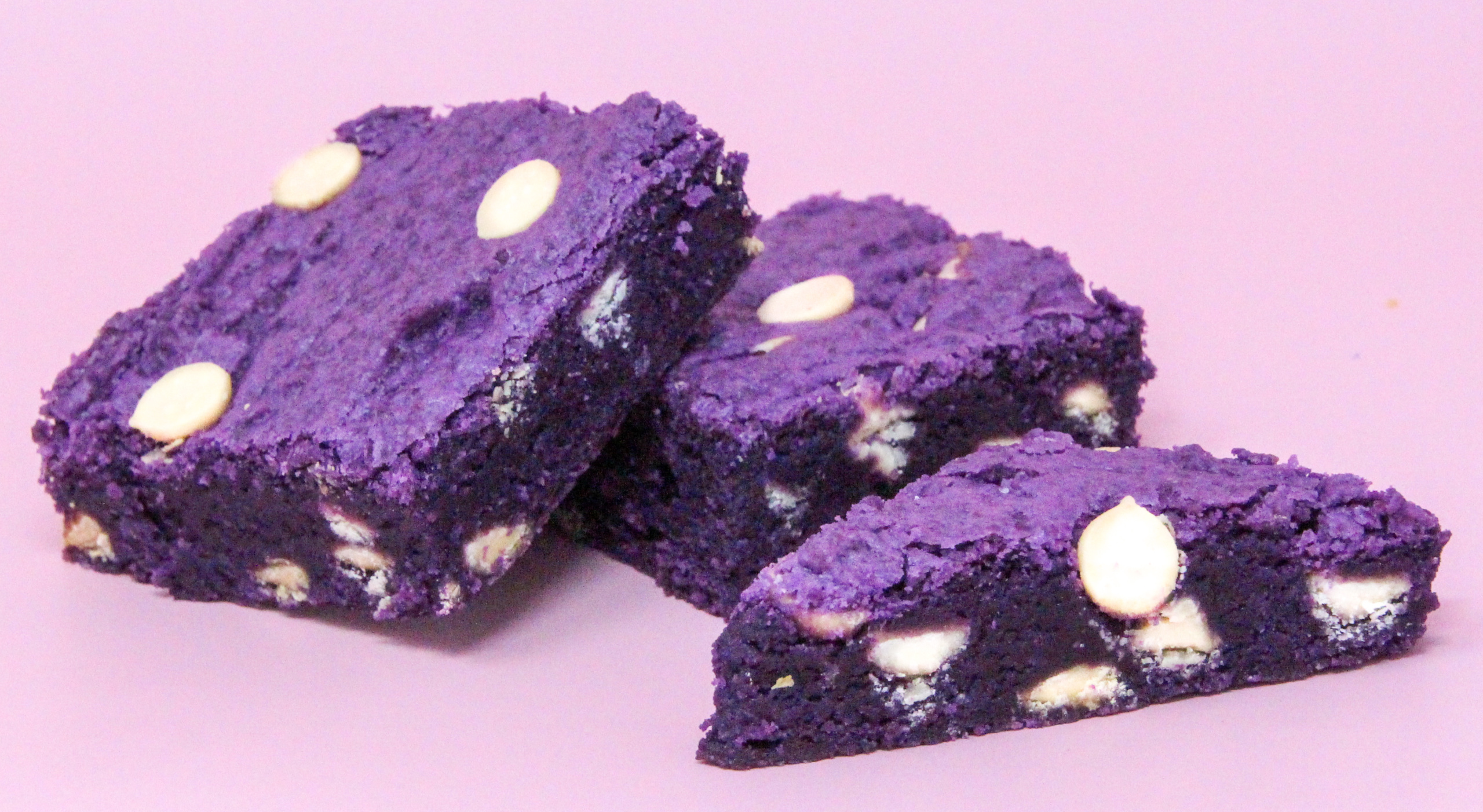 Ube Blondies uses ube jam (from a purple yam) for added sweetness and adds a fun purple color to the blondies. These have a perfect chewy texture with white chocolate chips providing a creamy contrast. Recipe shared with permission granted by Leslie Karst, author of WATERS OF DESTRUCTION.