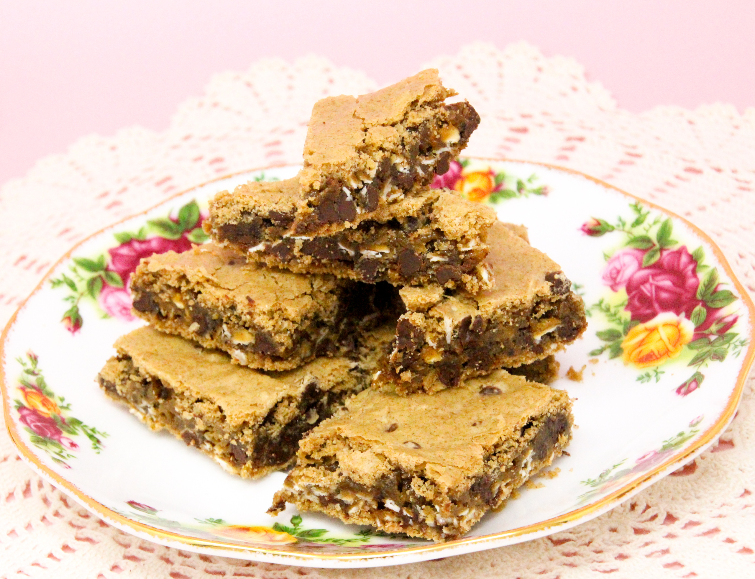 Oatmeal Chocolate Chip Bars are rich, chewy, and oh-so-yummy! The oatmeal provides a nice texture to the bars, and there is a decadent amount of chocolate chips to keep the bars gooey. Recipe shared with permission granted by Emmeline Duncan, author of FATAL BROUHAHA. 