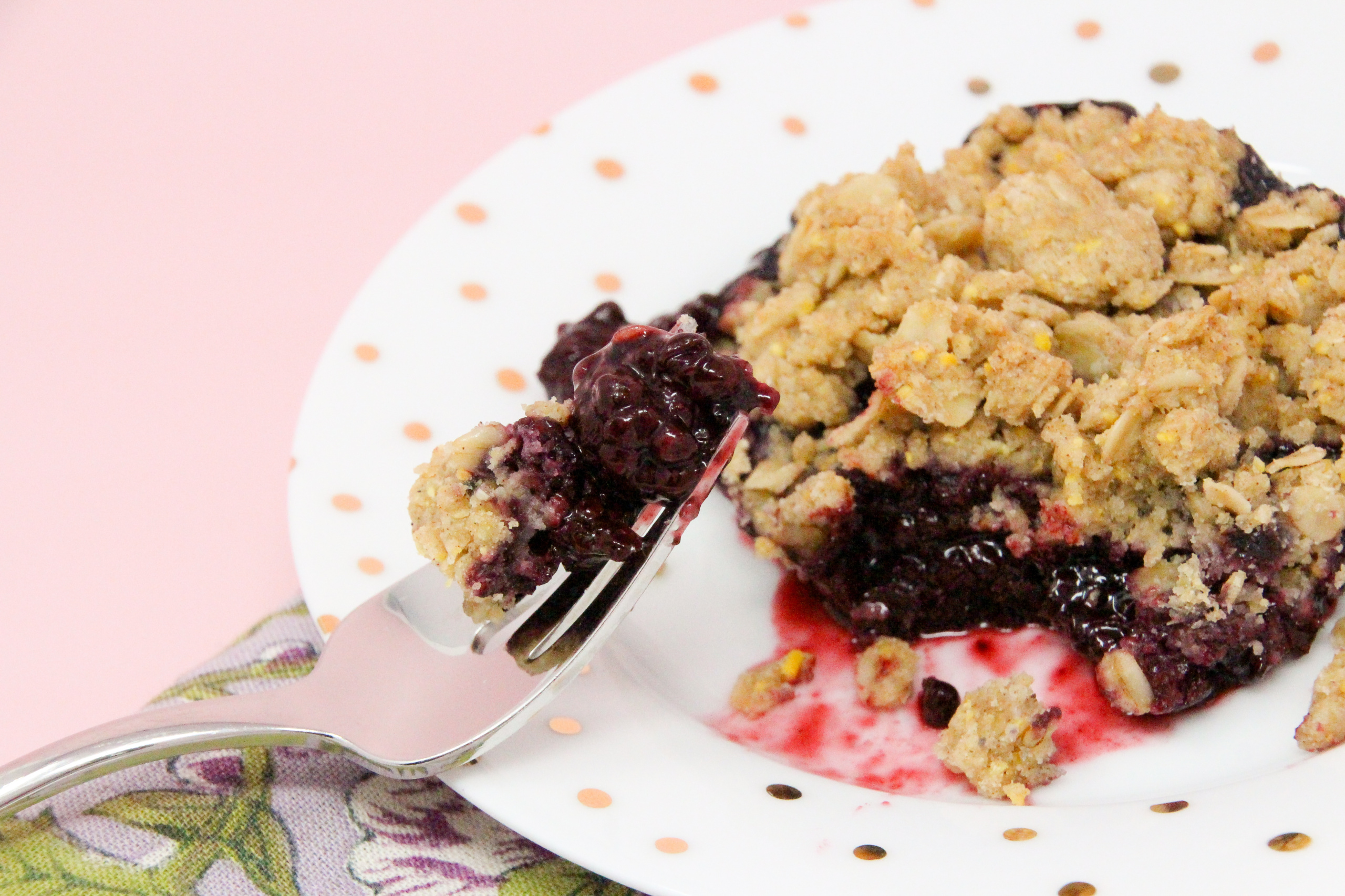 Blackberry Crumble Cobbler starts with a sweetened layer of juicy blackberries then topped with a crunchy oat and cornmeal crumble. Delicious on it's own, it's summery perfection when served with ice cream! Recipe shared with permission granted by Gigi Pandian, author of THE LIBRARY GAME.
