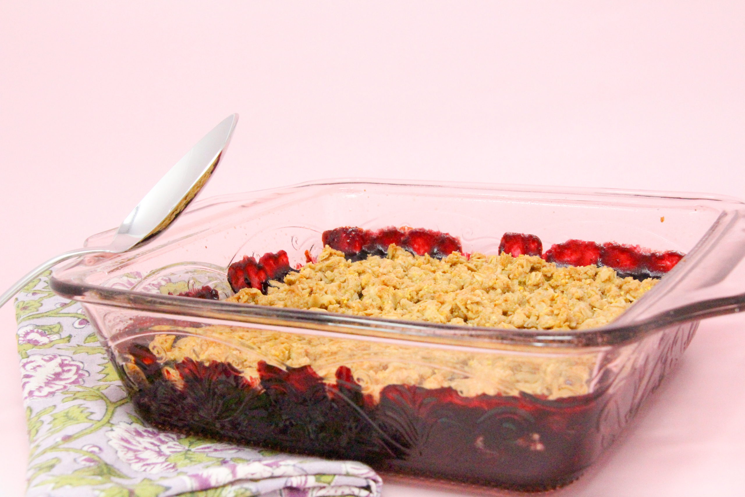 Blackberry Crumble Cobbler starts with a sweetened layer of juicy blackberries then topped with a crunchy oat and cornmeal crumble. Delicious on it's own, it's summery perfection when served with ice cream! Recipe shared with permission granted by Gigi Pandian, author of THE LIBRARY GAME.