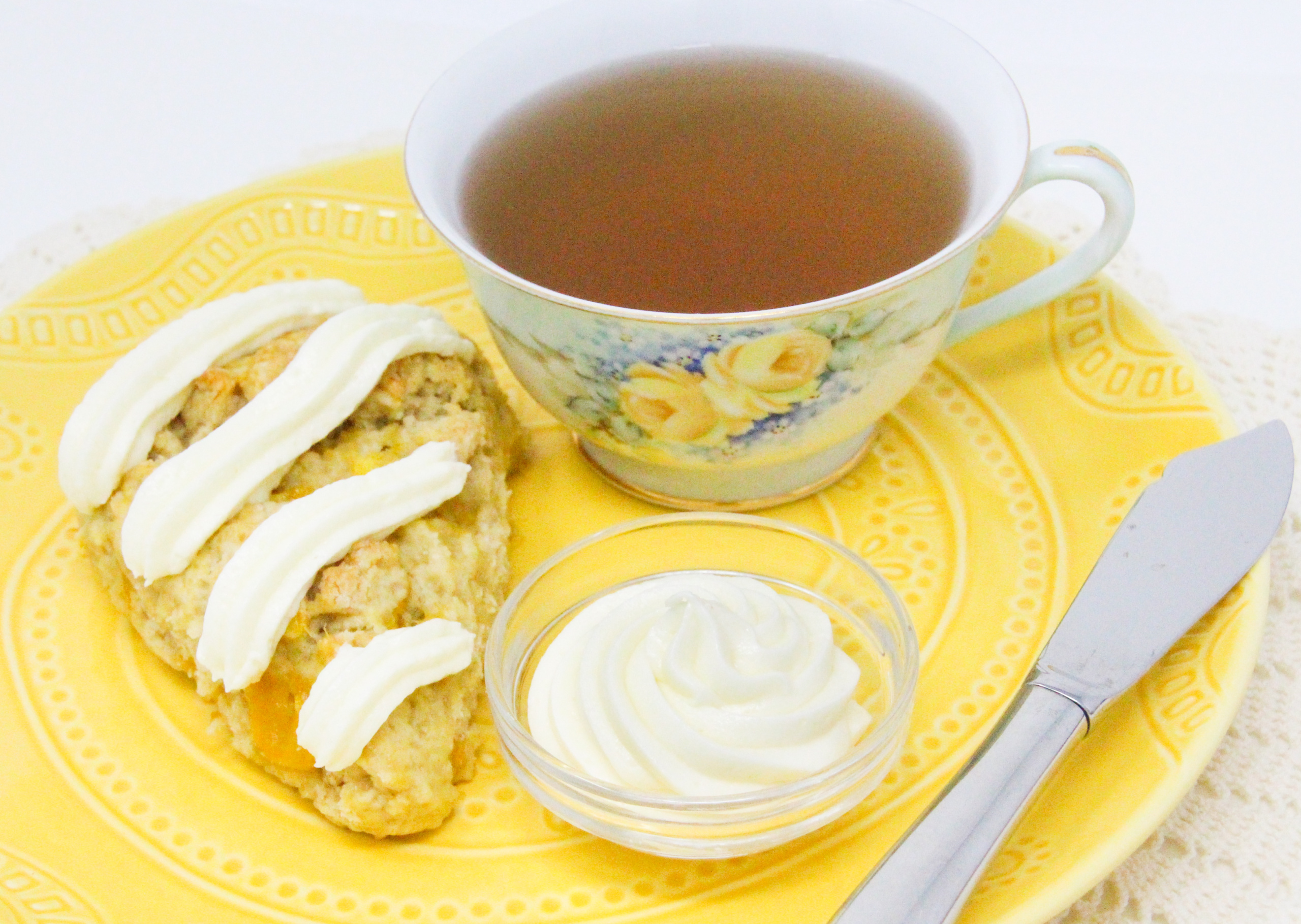 Mango Scones are flaky and rich thanks to a generous amount of butter and sour cream, but it’s the chunks of mango and cream cheese frosting that make them exceptional. Recipe shared with permission granted by Lucy Burdette, author of THE MANGO MURDERS.
