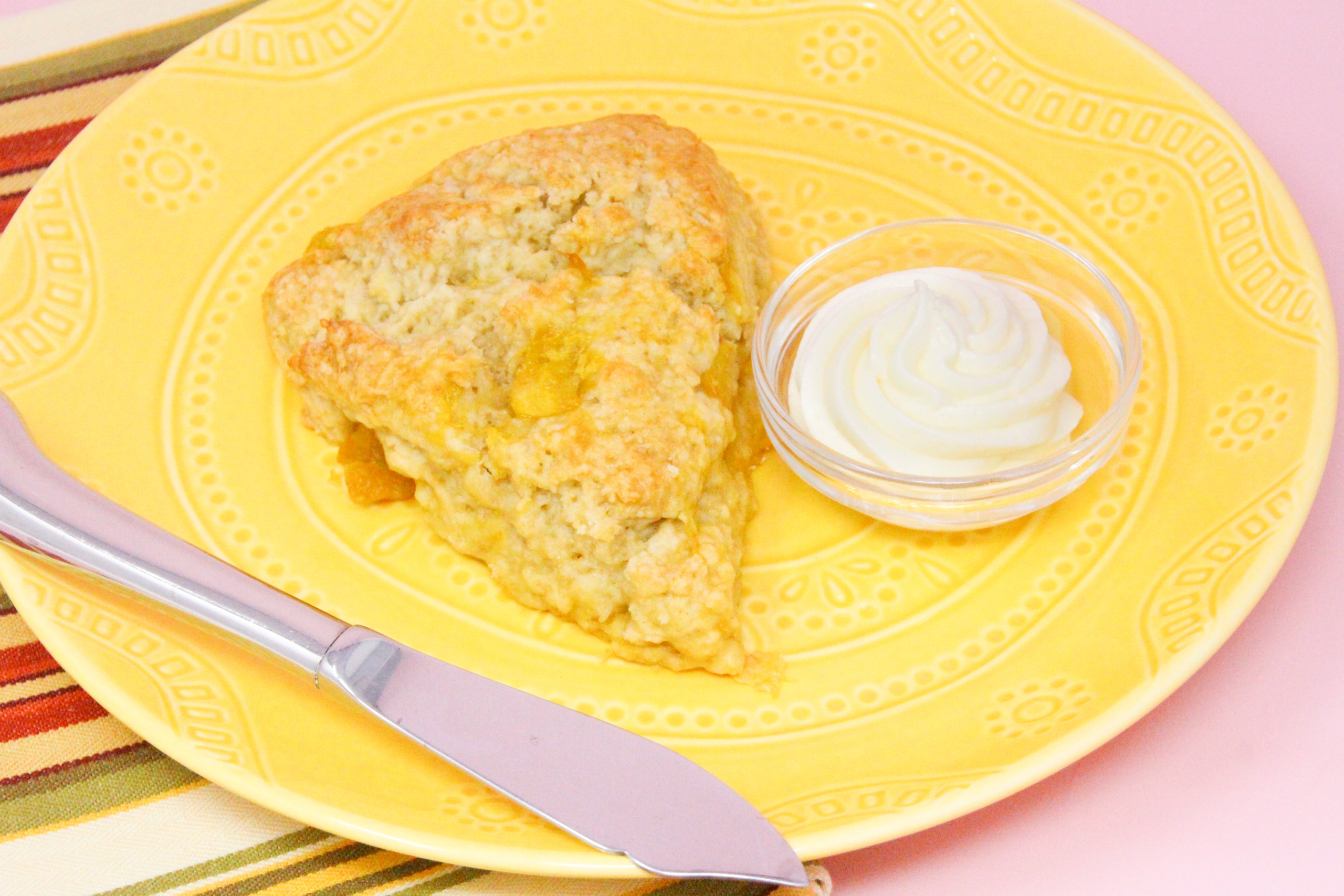 Mango Scones are flaky and rich thanks to a generous amount of butter and sour cream, but it’s the chunks of mango and cream cheese frosting that make them exceptional. Recipe shared with permission granted by Lucy Burdette, author of THE MANGO MURDERS.