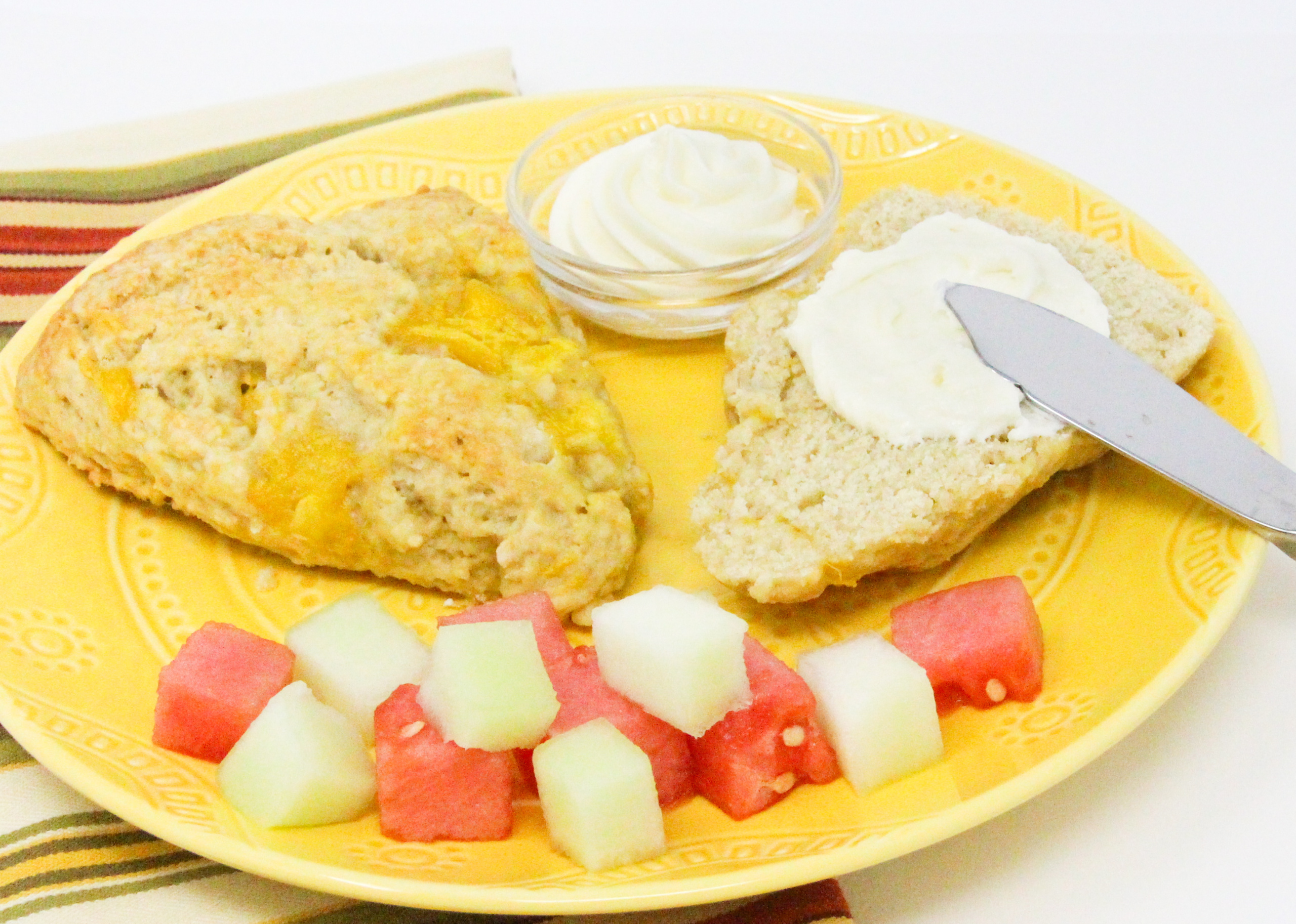 Mango Scones are flaky and rich thanks to a generous amount of butter and sour cream, but it’s the chunks of mango and cream cheese frosting that make them exceptional. Recipe shared with permission granted by Lucy Burdette, author of THE MANGO MURDERS.