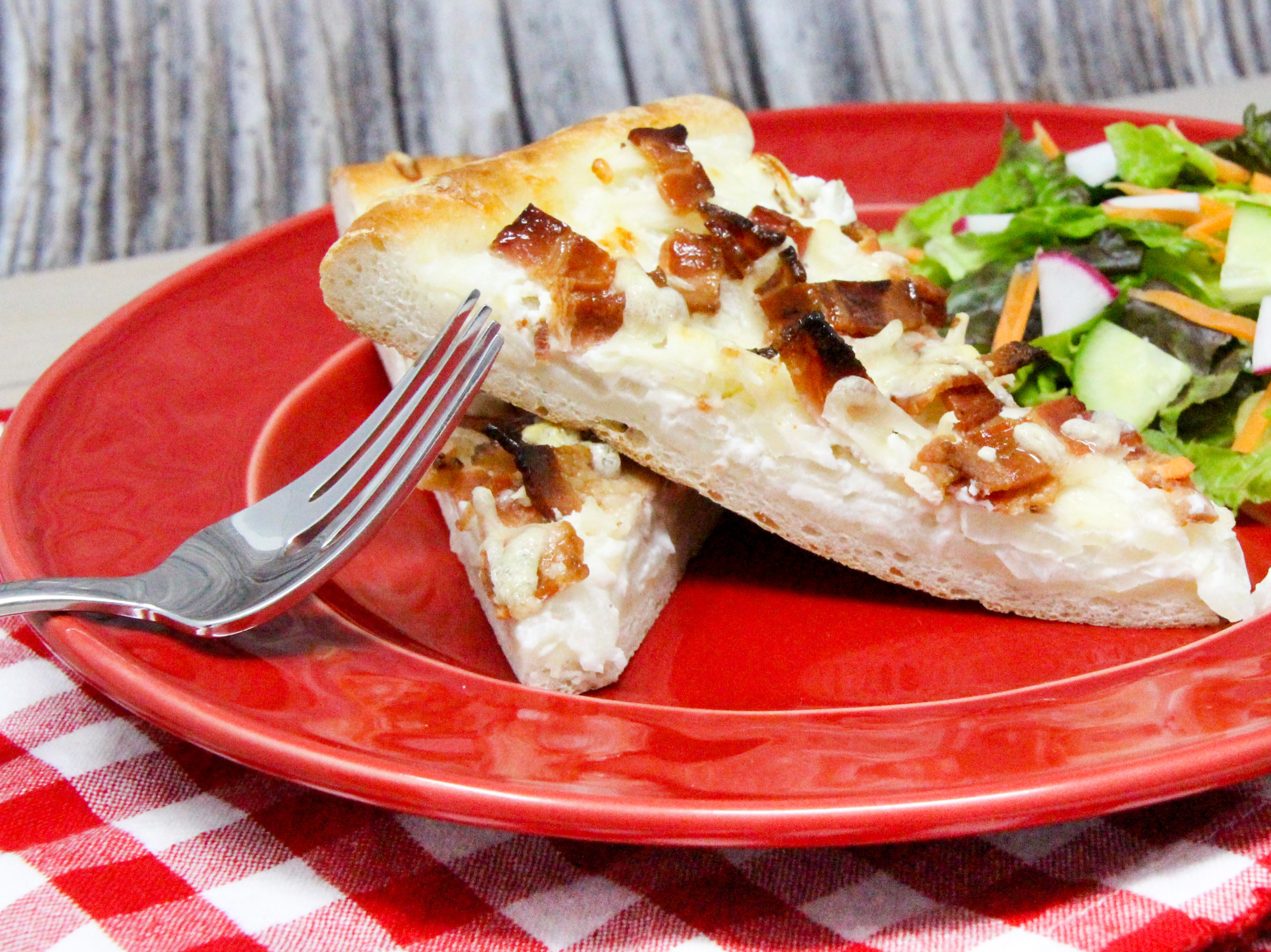 Tarte Flambée is a traditional dish is from Alsace, and is similar to a thin-crust pizza topped with crème fraîche, onions, and lardons or bacon. Rich and oh so yummy, this is a decadent dish served either as a main course or as an appetizer. Recipe shared with permission granted by Ann Claire, author of A CYCLIST'S GUIDE TO VILLIANS & VINES.