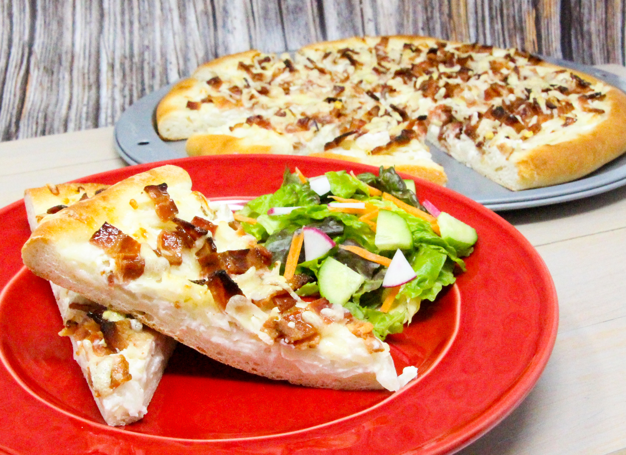 Tarte Flambée is a traditional dish is from Alsace, and is similar to a thin-crust pizza topped with crème fraîche, onions, and lardons or bacon. Rich and oh so yummy, this is a decadent dish served either as a main course or as an appetizer. Recipe shared with permission granted by Ann Claire, author of A CYCLIST'S GUIDE TO VILLIANS & VINES.