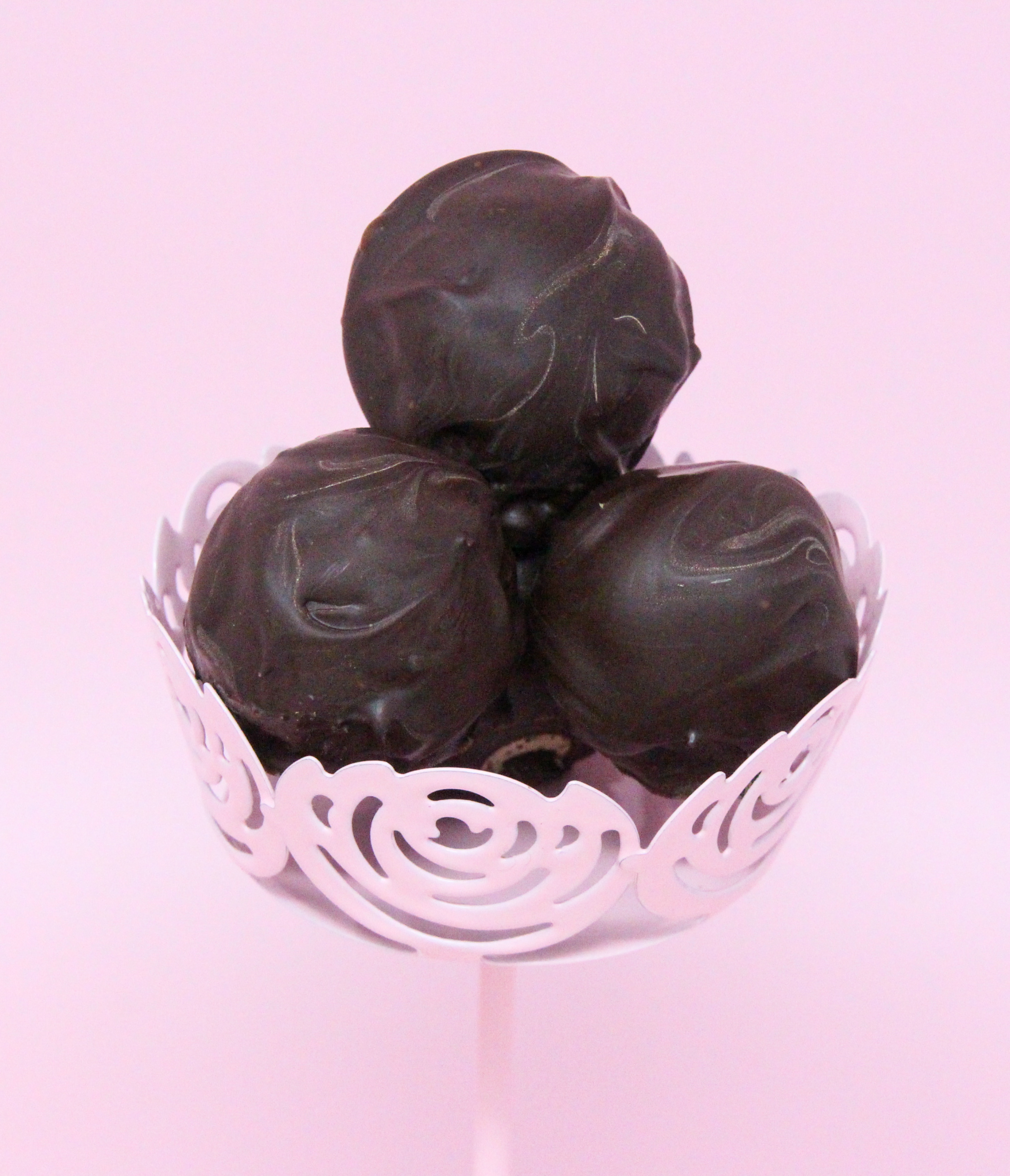 Fig, Ginger, Cardamom Truffles are a tempting combination of figs with spices, all enrobed in dark chocolate, making these scrumptious morsels a perfect bite to end dinner with. Recipe shared with permission granted by Molly MacRae, author of THERE'LL BE SHELL TO PAY.