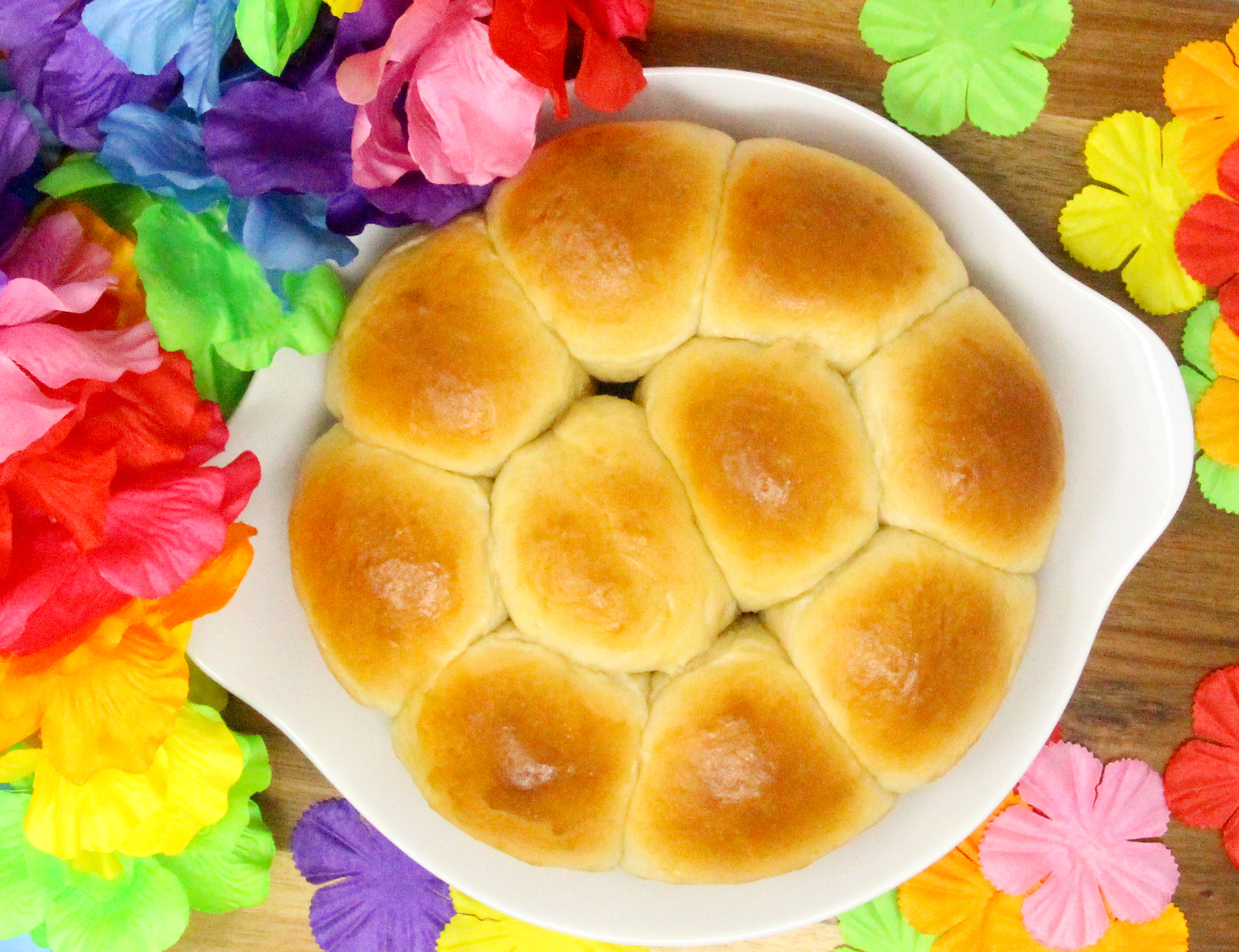 Soft and sweet, Hawaiian Rolls have a tropical taste thanks to the use of pineapple juice. These are perfect on their own, slathered with butter, or make an ideal base for BBQ pulled pork sliders, Hawaiian style. Recipe created by Cinnamon & Sugar for Catherine Bruns, author of DEATH OF THE HULA GIRL. 