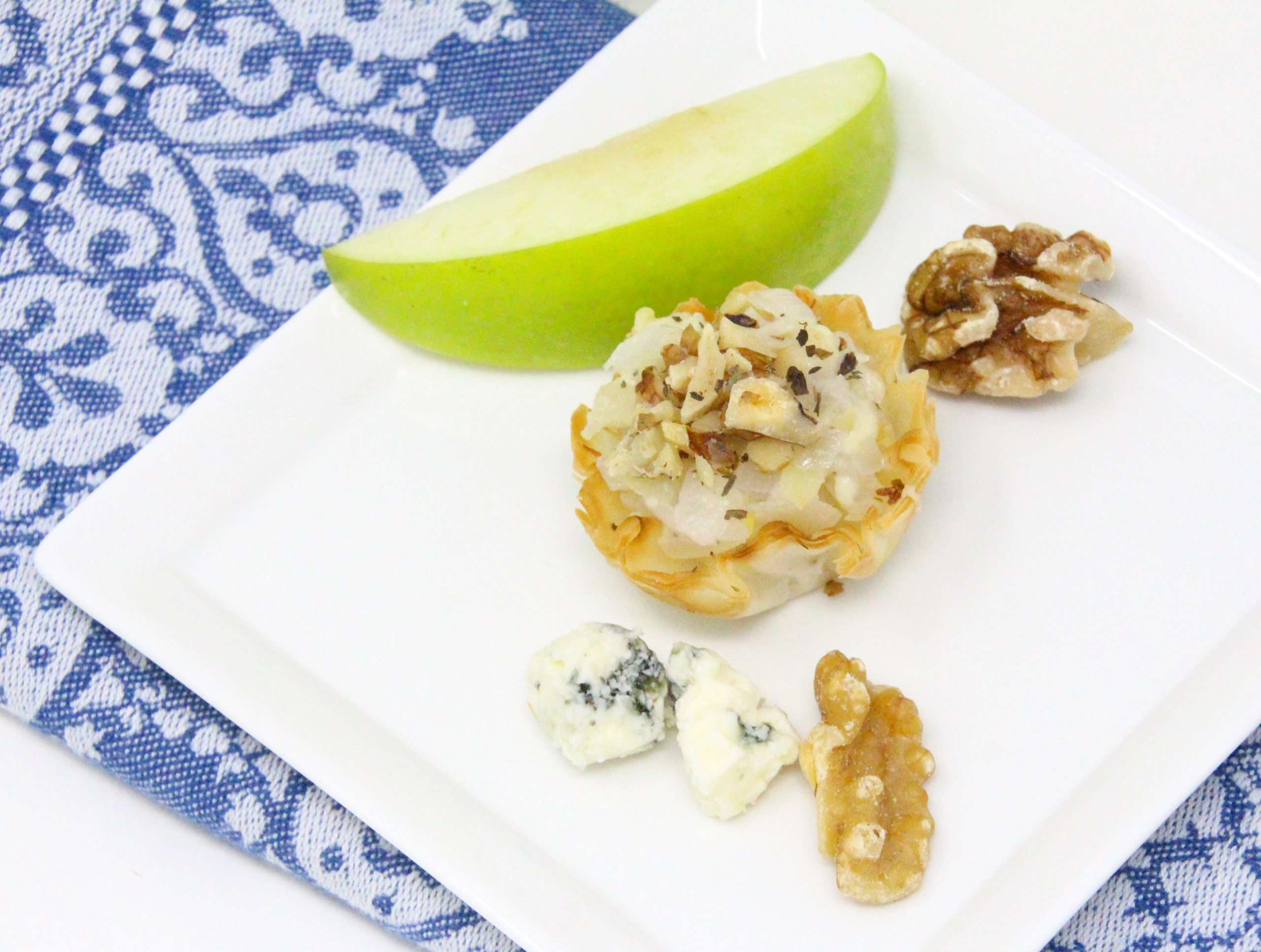 Grant’s Bleu Cheese Tarts--mini bite-sized appetizers-- are filled with a sweet and savory mixture of apple, bleu cheese, and onion. These easy to make nibbles go perfectly with a glass of white wine and will enhance any appetizer platter. Recipe shared with permission granted by Linda Reilly, author of EDAM AND WEEP. 